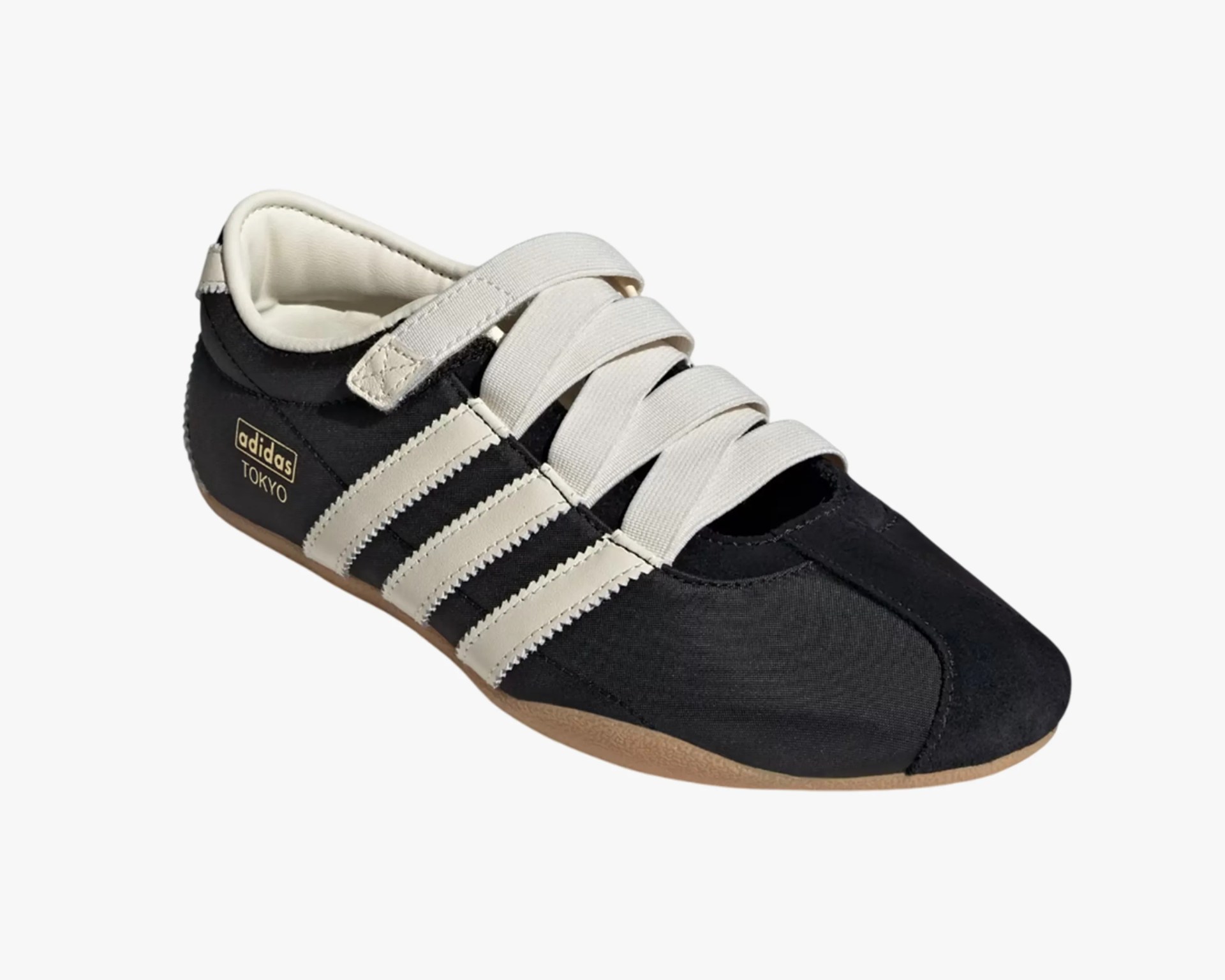 Black Adidas Tokyo sneaker with white stripes, wide white laces, and gum sole.