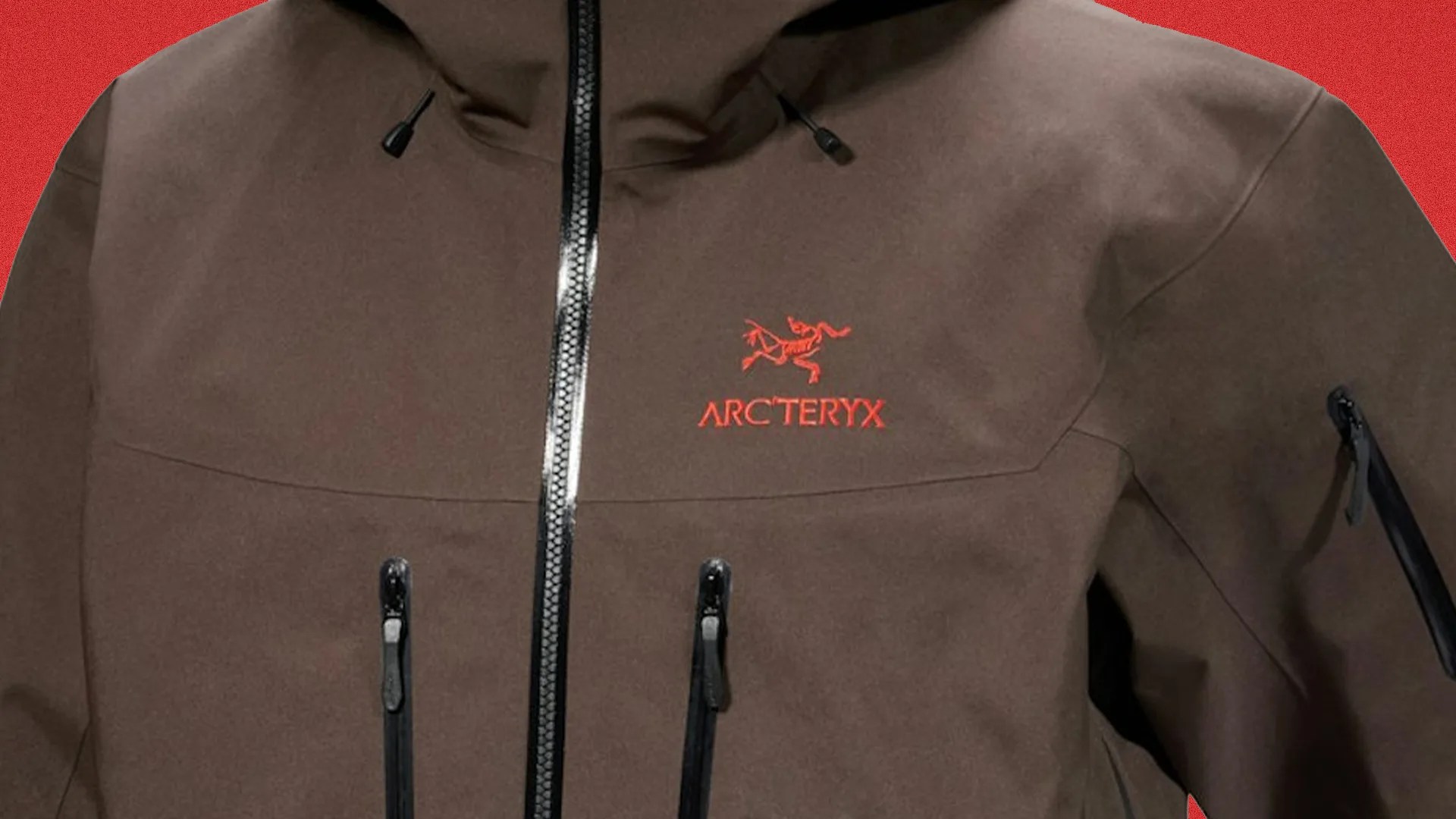 Brown Arc'teryx jacket with black zippers and red logo on the chest against a red background.