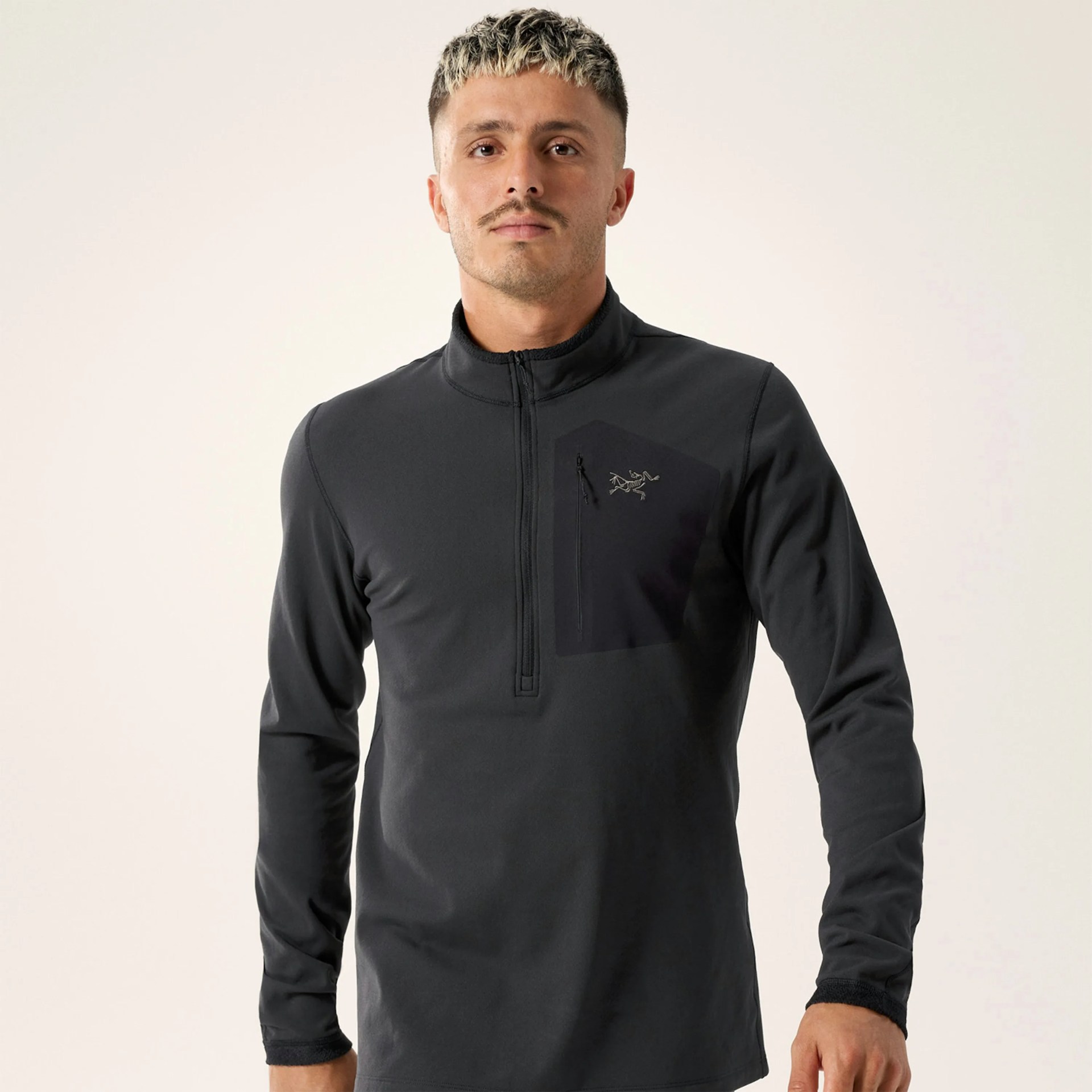 Black long-sleeve quarter-zip pullover with a zippered chest pocket and logo on the left chest.