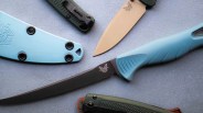 Two Benchmade knives with blue handles and sheaths, and two folding knives with green handles on a gray surface.