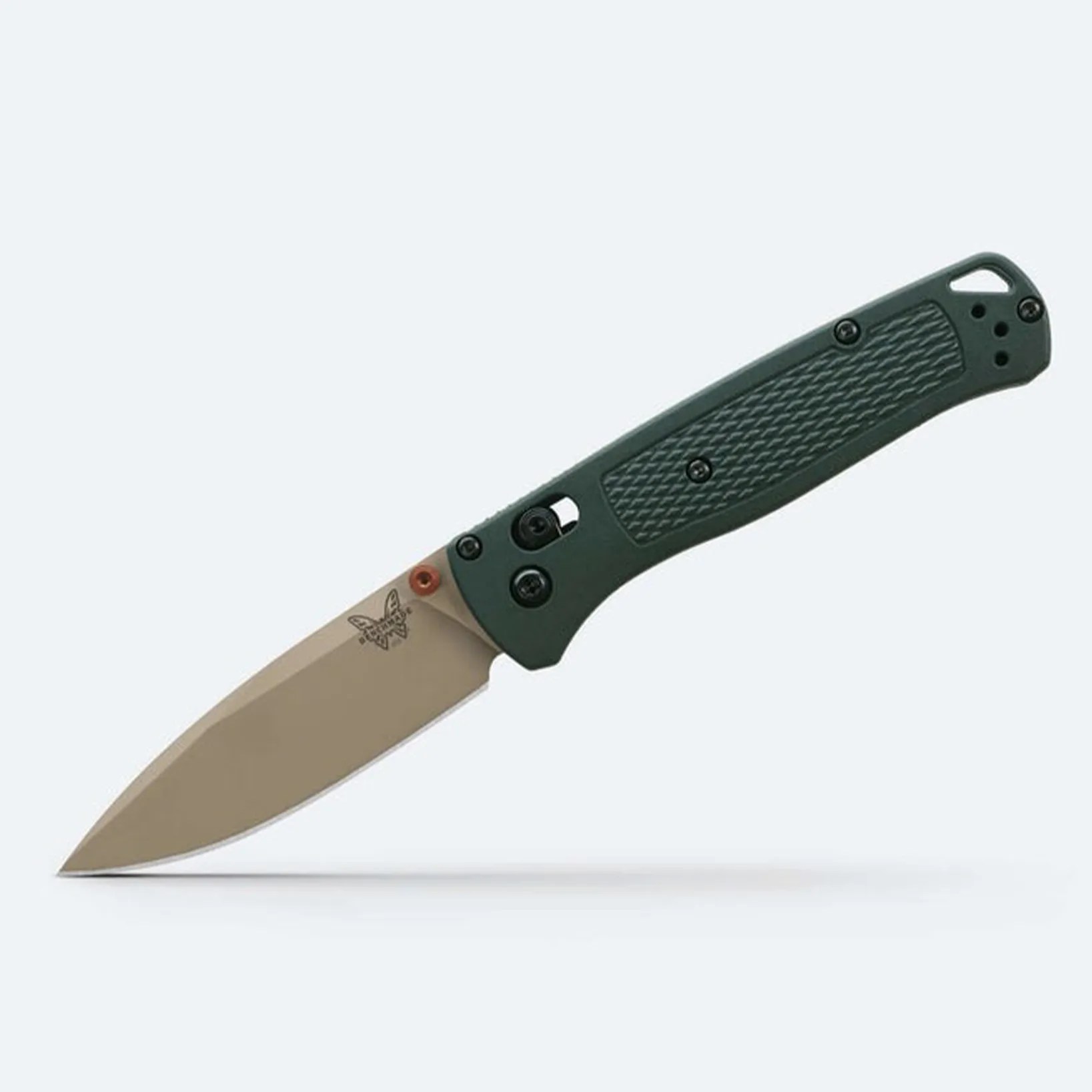Folding knife with tan blade and dark green textured handle on a white background.