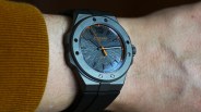 Matte gray Chopard wristwatch with textured dial, orange accents, and black rubber strap worn on a wrist.