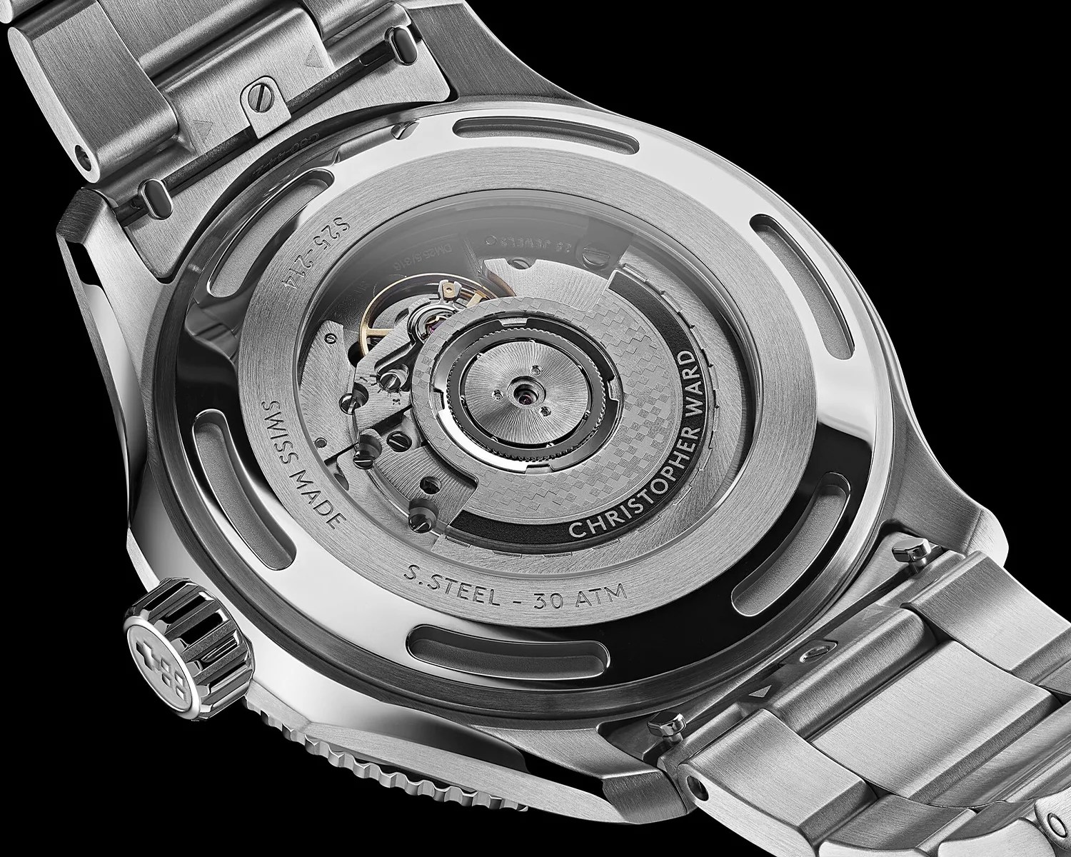 Close-up of the back of a stainless steel Christopher Ward watch showing the automatic movement through a transparent case back.