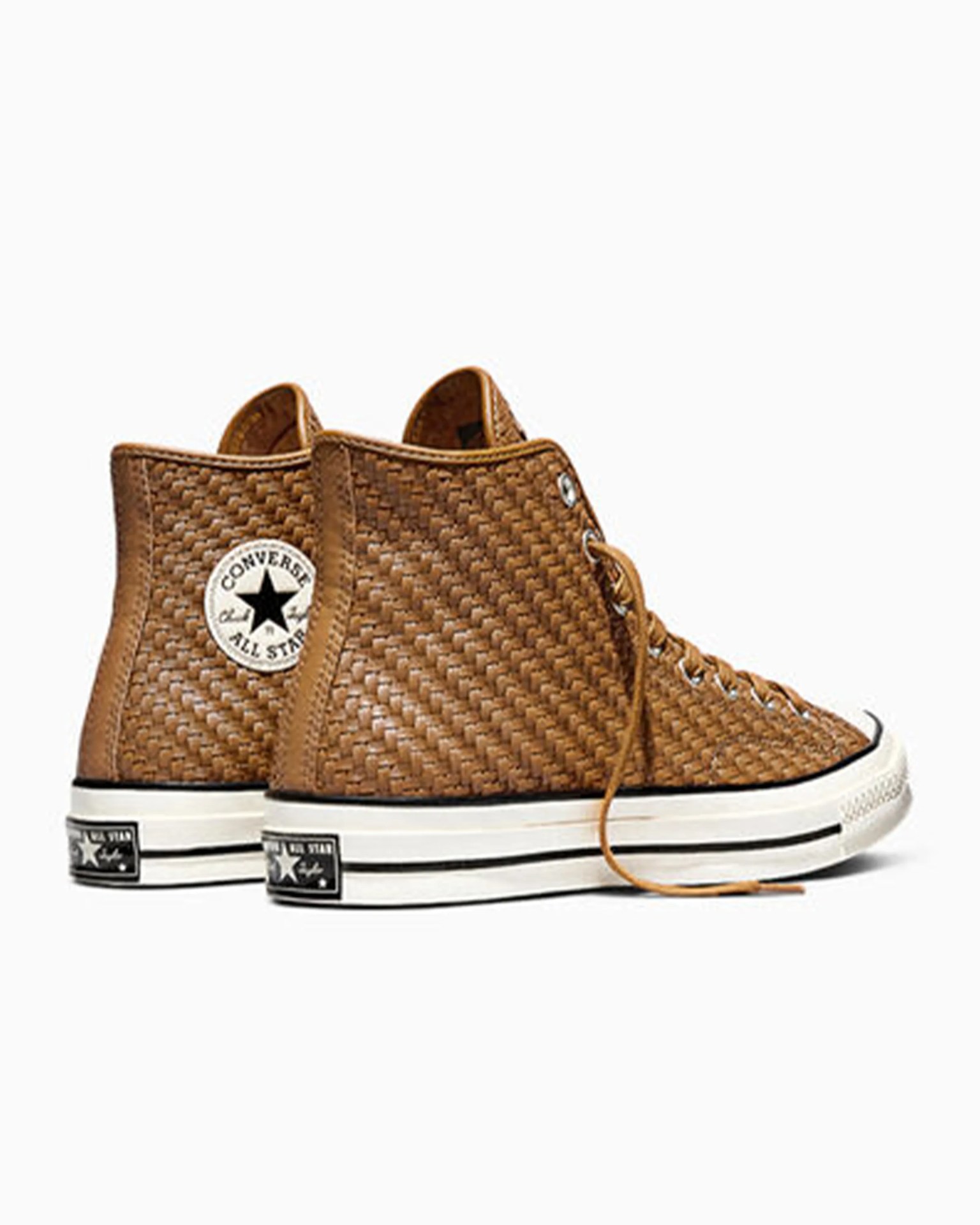 Pair of brown woven leather Converse All Star high-top sneakers with white rubber soles and black trim.