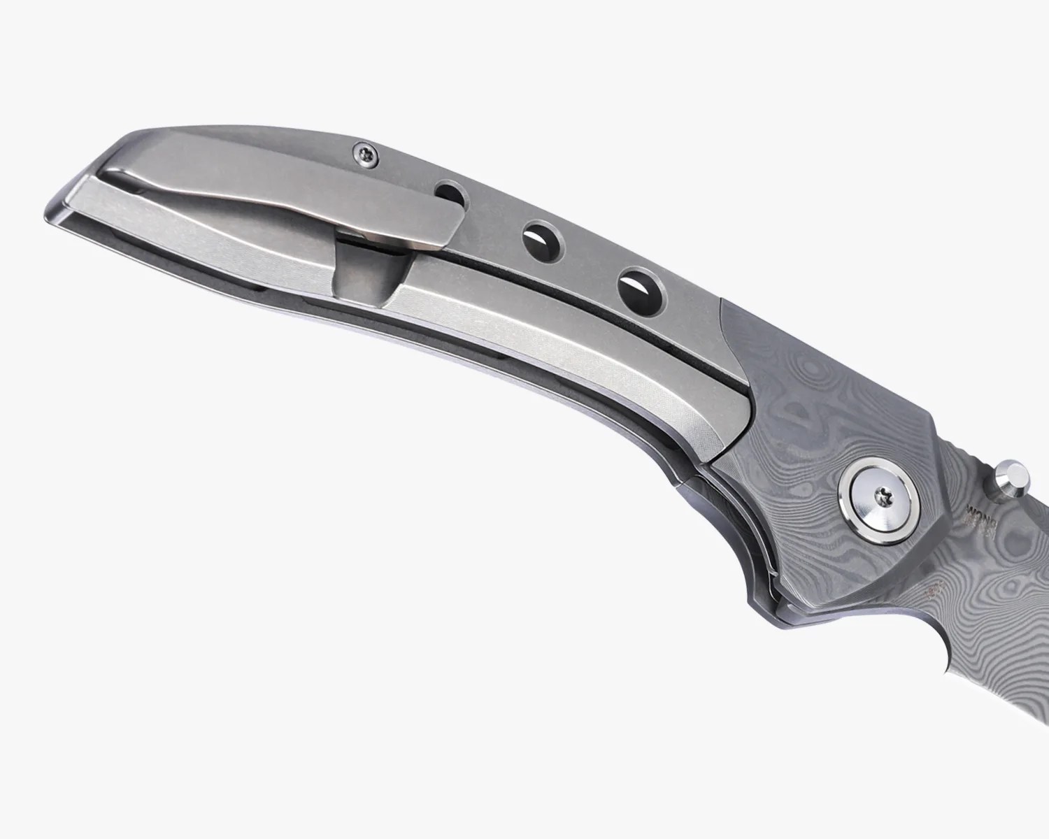 Close-up of a gray folding knife handle with a metal pocket clip and three circular holes.