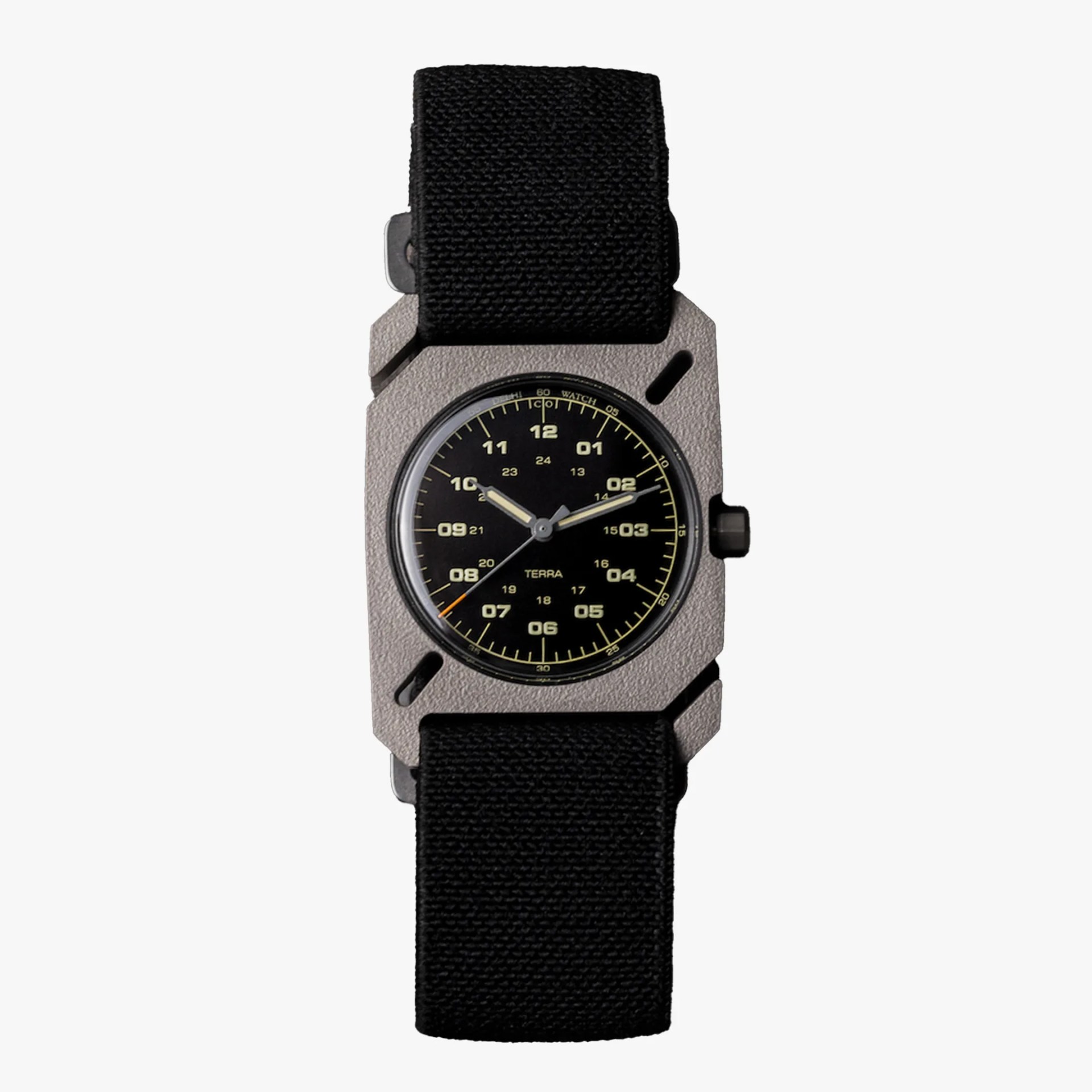 Black dial wristwatch with beige numerals, textured silver rectangular case, and black fabric strap.