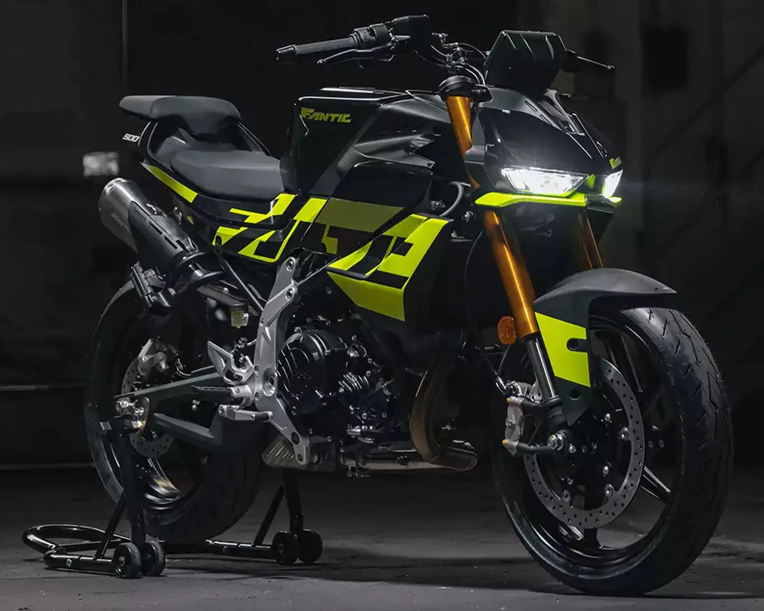 Black and neon yellow Fantic 500 motorcycle with gold front forks on a rear stand.