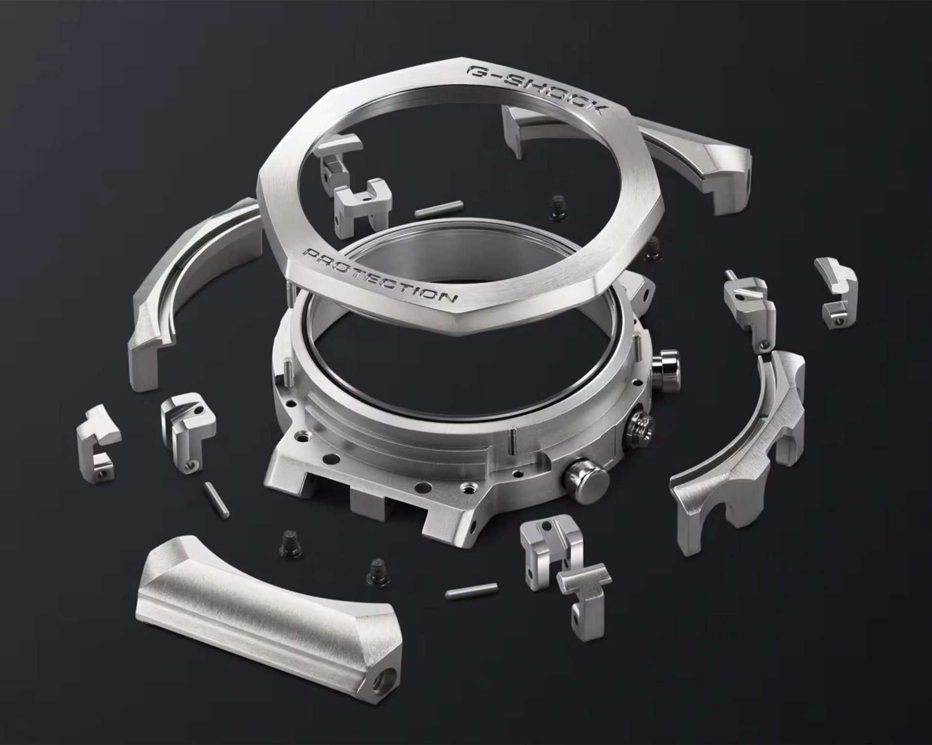 Disassembled silver metal G-Shock watch case parts arranged on a black surface.