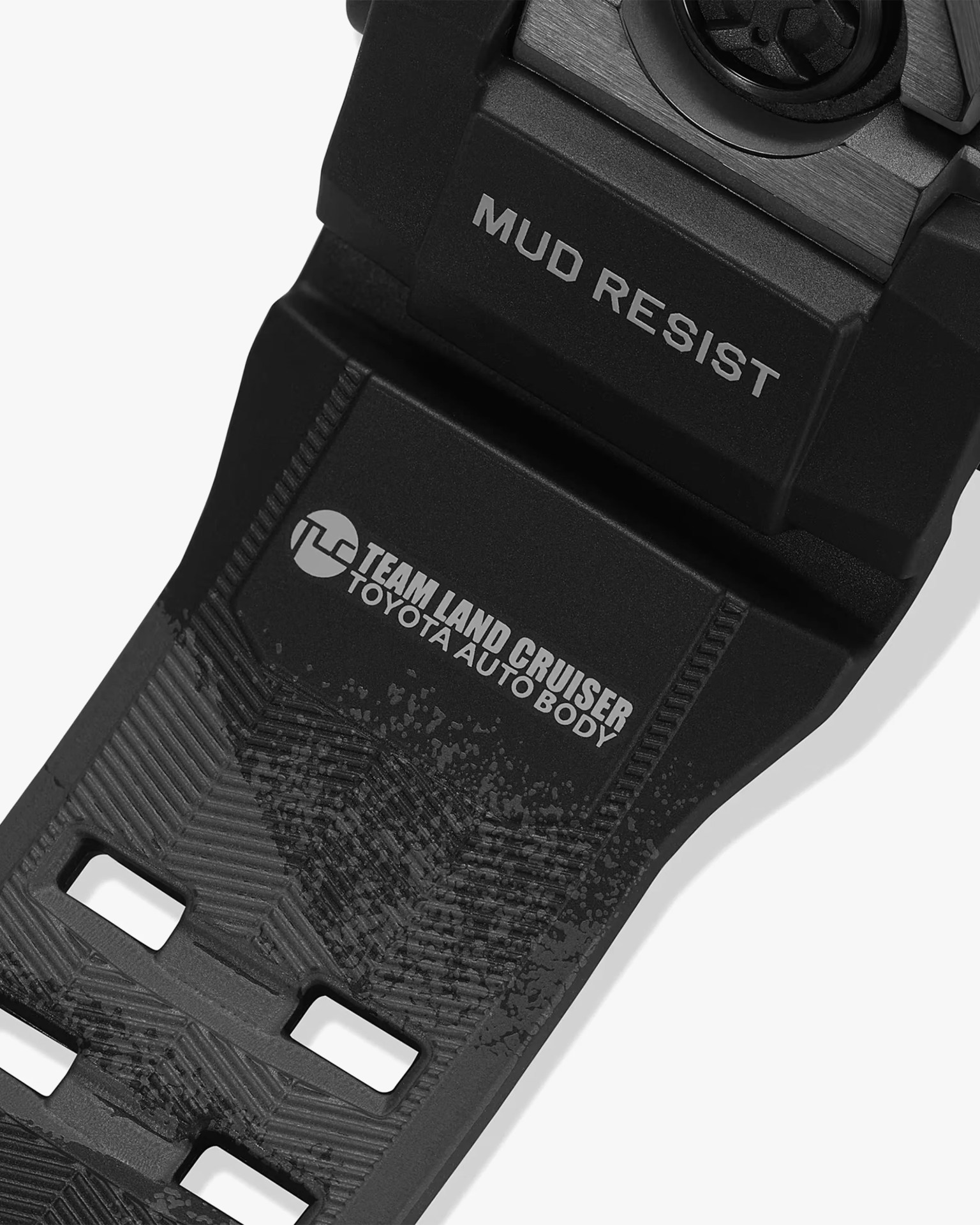 Black watch strap with textured pattern and white text reading "MUD RESIST" and "TEAM LAND CRUISER TOYOTA AUTO BODY.