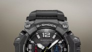 Close-up of a black Casio G-Shock Mudmaster watch face with white and yellow hands and rugged bezel.