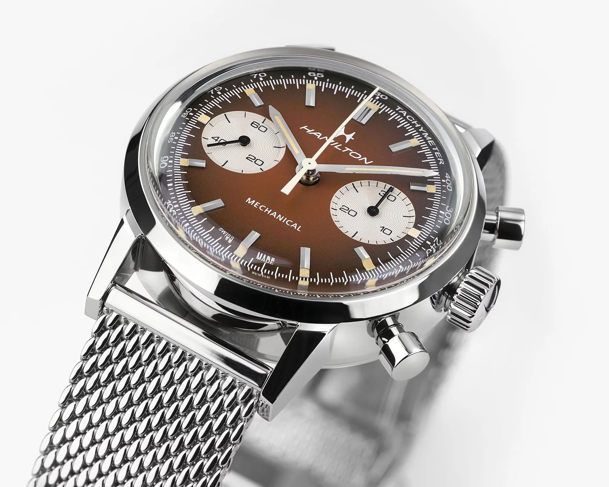 Hamilton mechanical chronograph watch with brown dial, silver subdials, and stainless steel mesh strap.