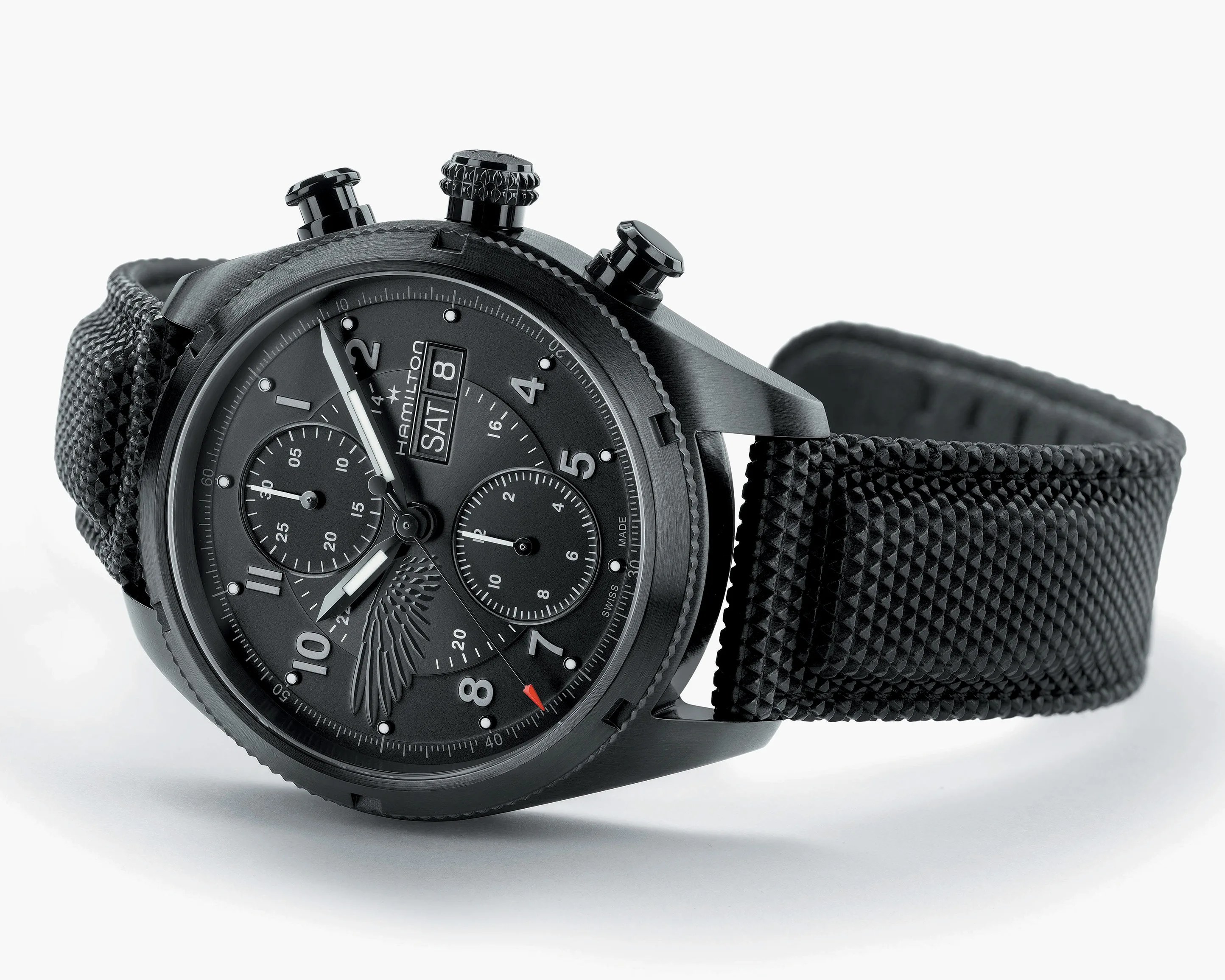 Black Hamilton chronograph watch with textured black strap and day-date display on dial.