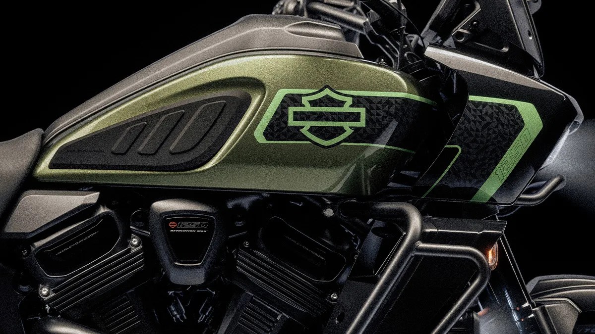 Close-up of a green and black Harley-Davidson motorcycle fuel tank with "1250" and engine details visible.