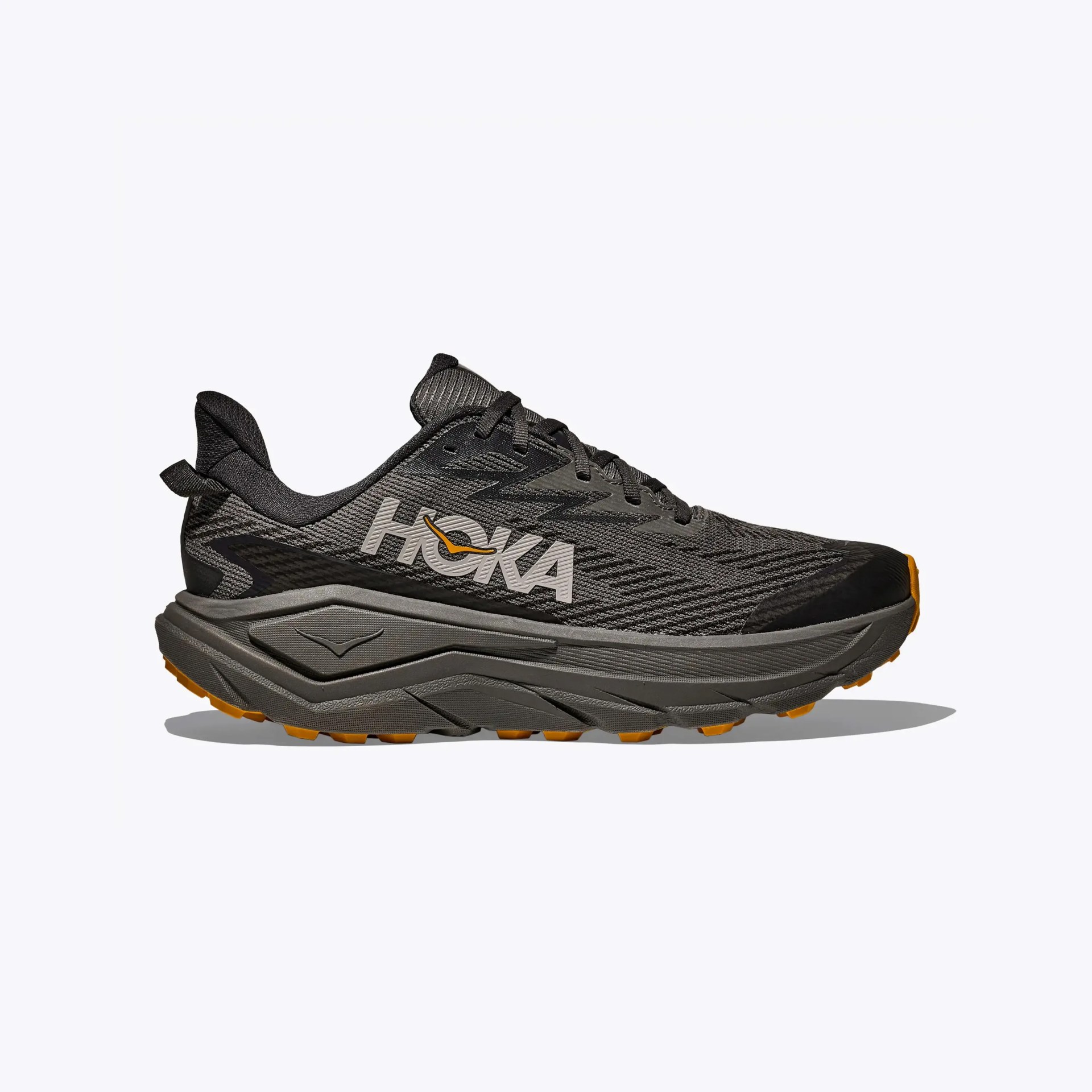 Dark gray and black HOKA running shoe with thick sole and orange accents on the outsole.