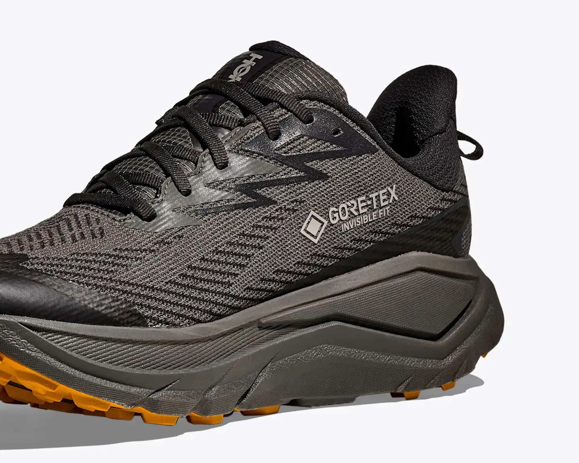 Gray and black Gore-Tex running shoe with orange tread and black laces.