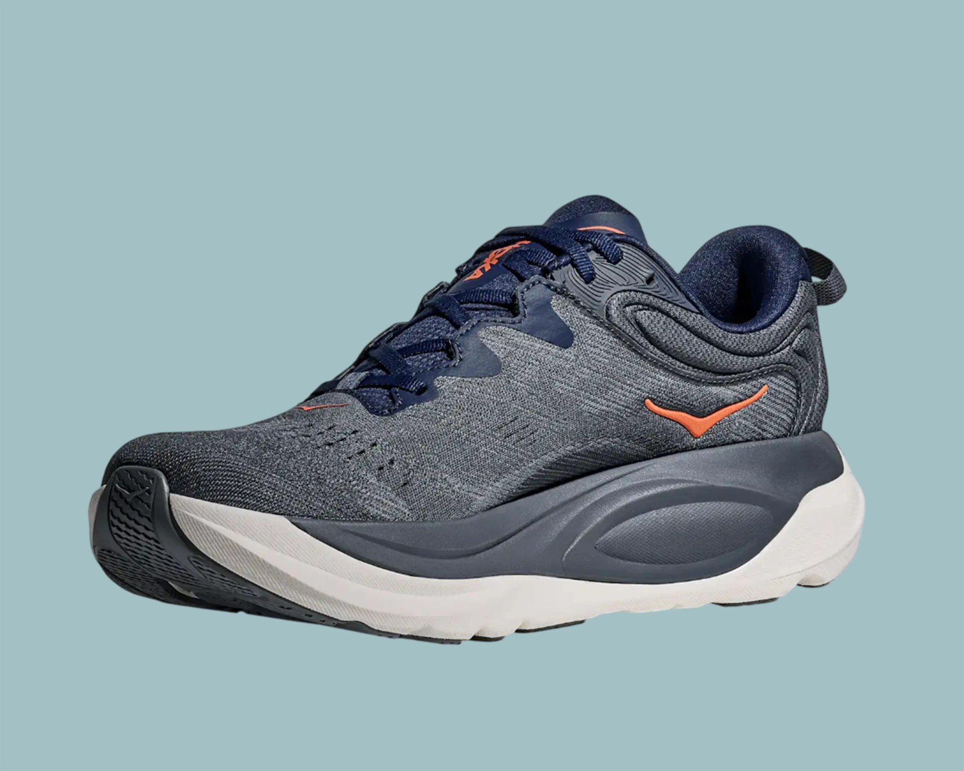 Dark gray and navy running shoe with orange logo and white sole on a light blue background.