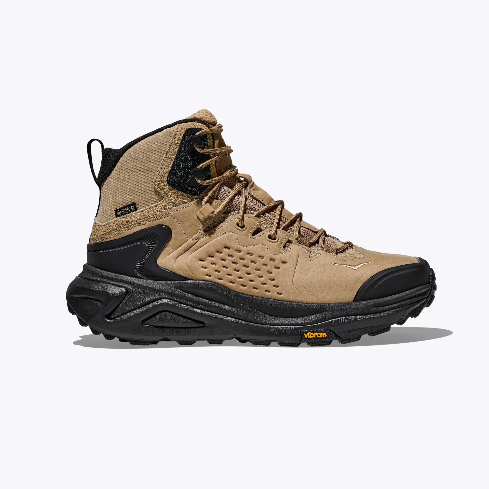 Tan and black high-top hiking boot with Vibram sole and Gore-Tex label on a white background.
