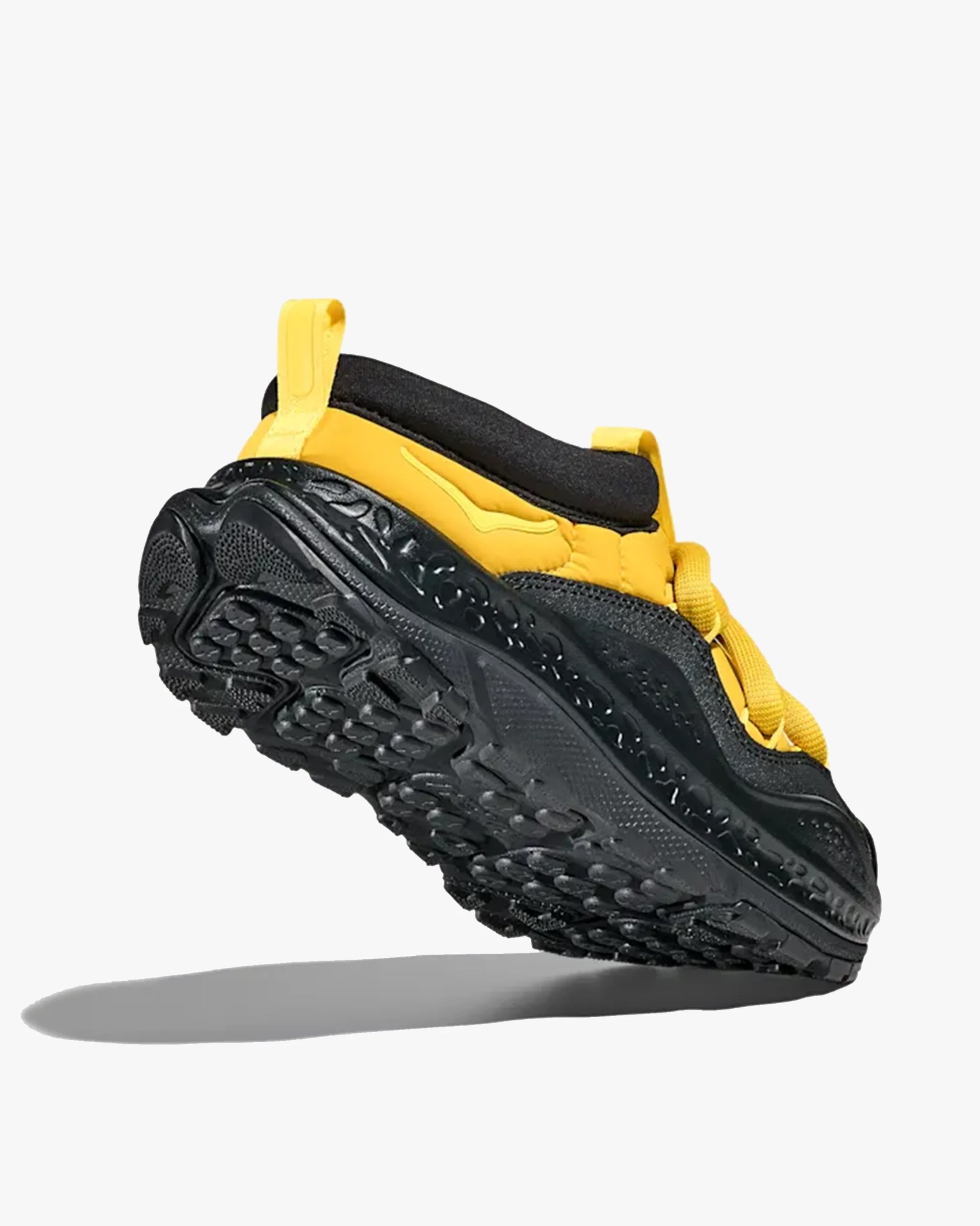 Yellow and black sneaker with textured black sole and yellow pull tabs.
