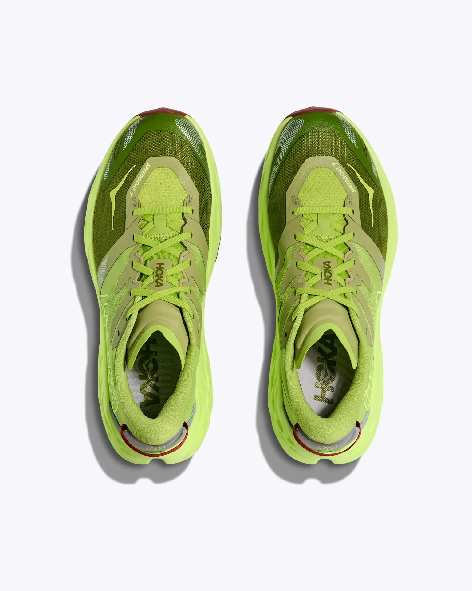 Pair of neon green Hoka Speedgoat 4 running shoes viewed from above on a white background.