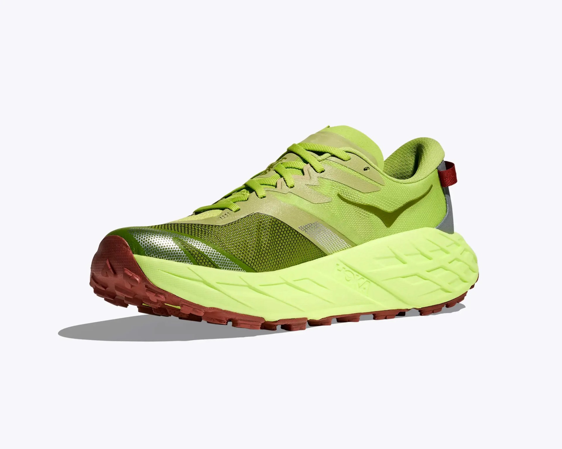 Light green running shoe with thick sole and red-brown outsole, featuring a red pull tab at the heel.