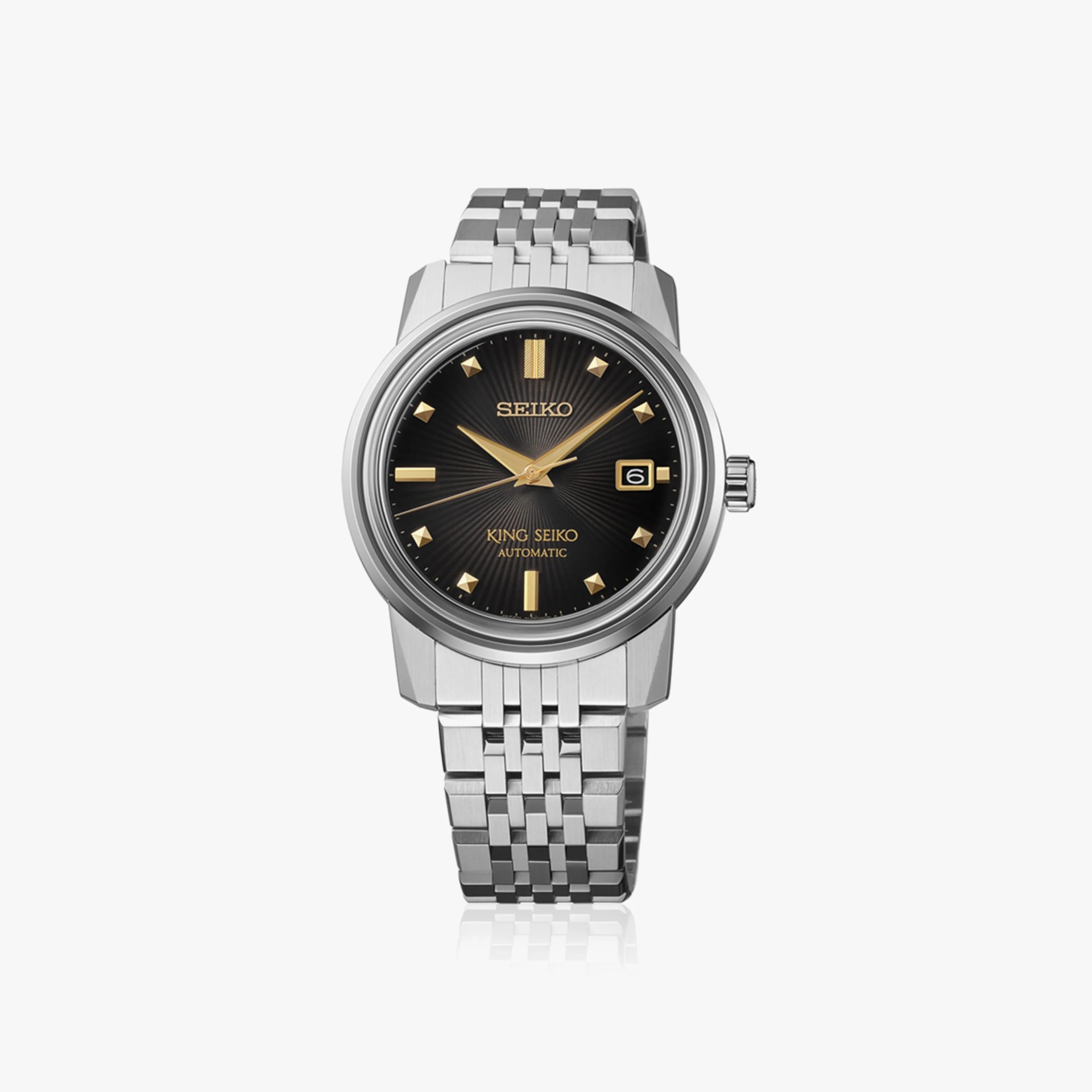Silver stainless steel Seiko wristwatch with black dial, gold markers, and date display at 3 o'clock.