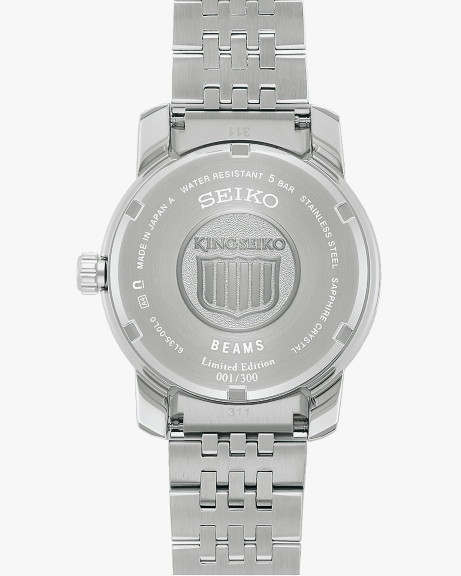 Back of a silver stainless steel Seiko King Seiko limited edition watch with engraved logo and metal bracelet.