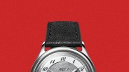 Silver wristwatch with black leather strap and white dial featuring black Arabic numerals and Japanese text.