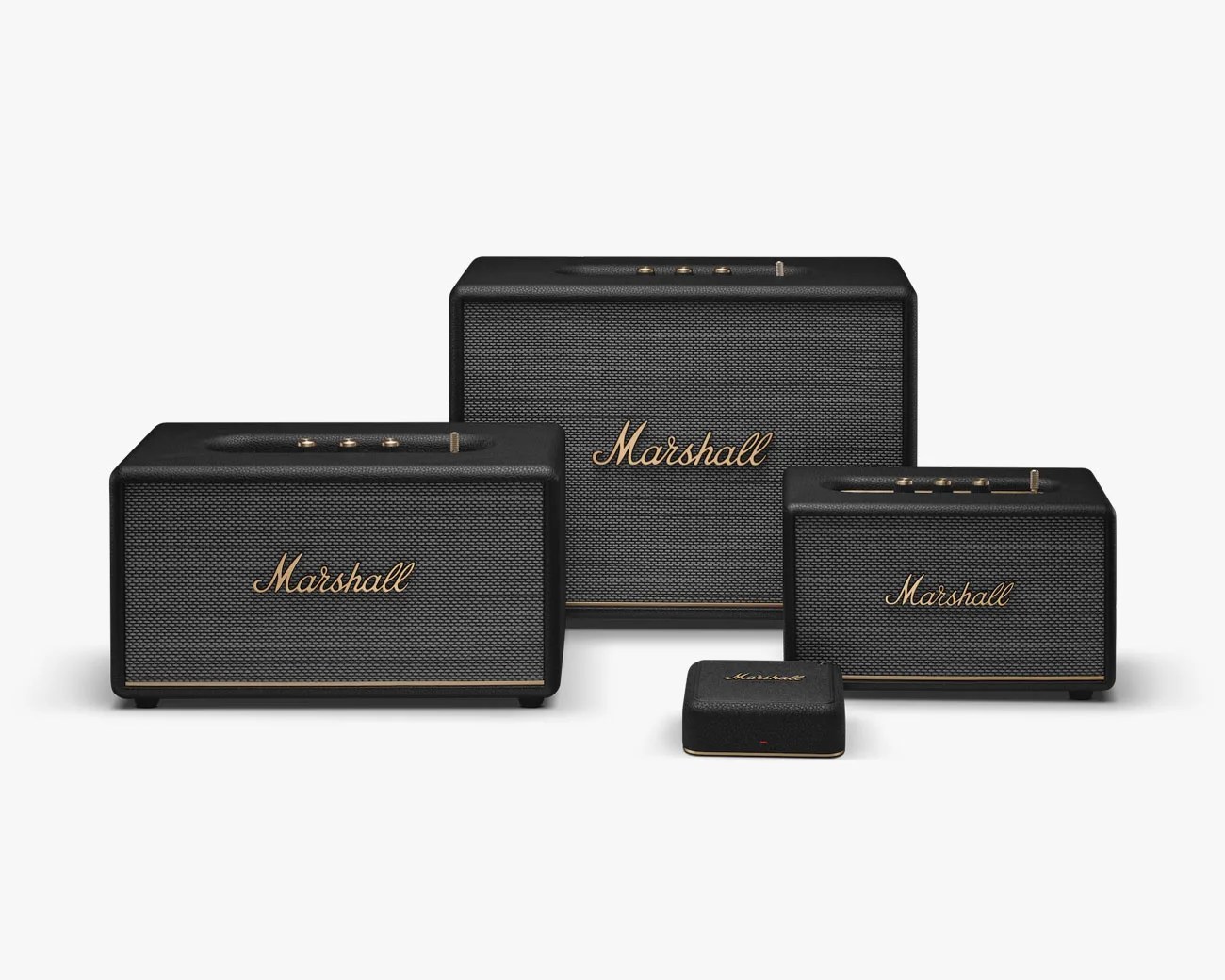 Four black Marshall speakers of varying sizes with gold accents and the Marshall logo on the front.
