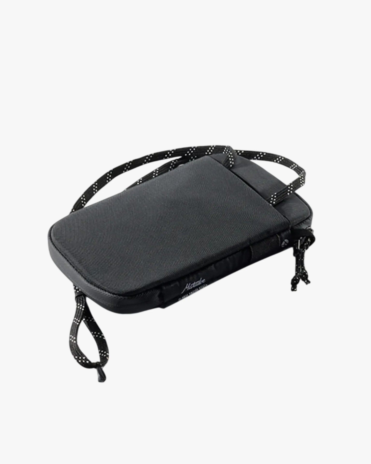 Black rectangular crossbody pouch with a zippered closure and a black-and-white patterned strap.