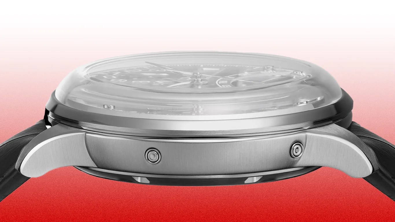 Side view of a silver stainless steel watch case with a domed crystal and black leather strap.