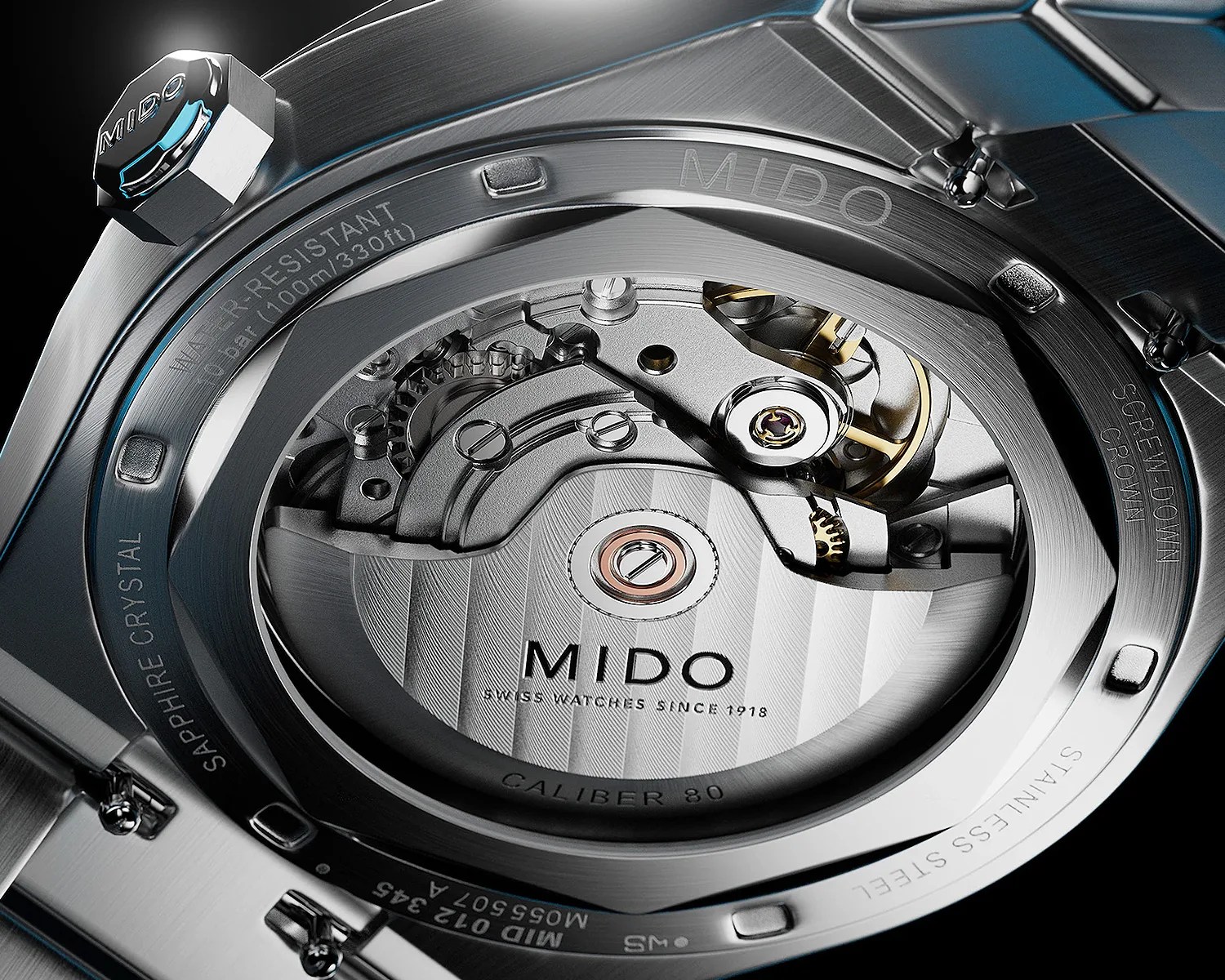 Close-up of the back of a MIDO stainless steel watch showing the Caliber 80 automatic movement through a sapphire crystal case back.