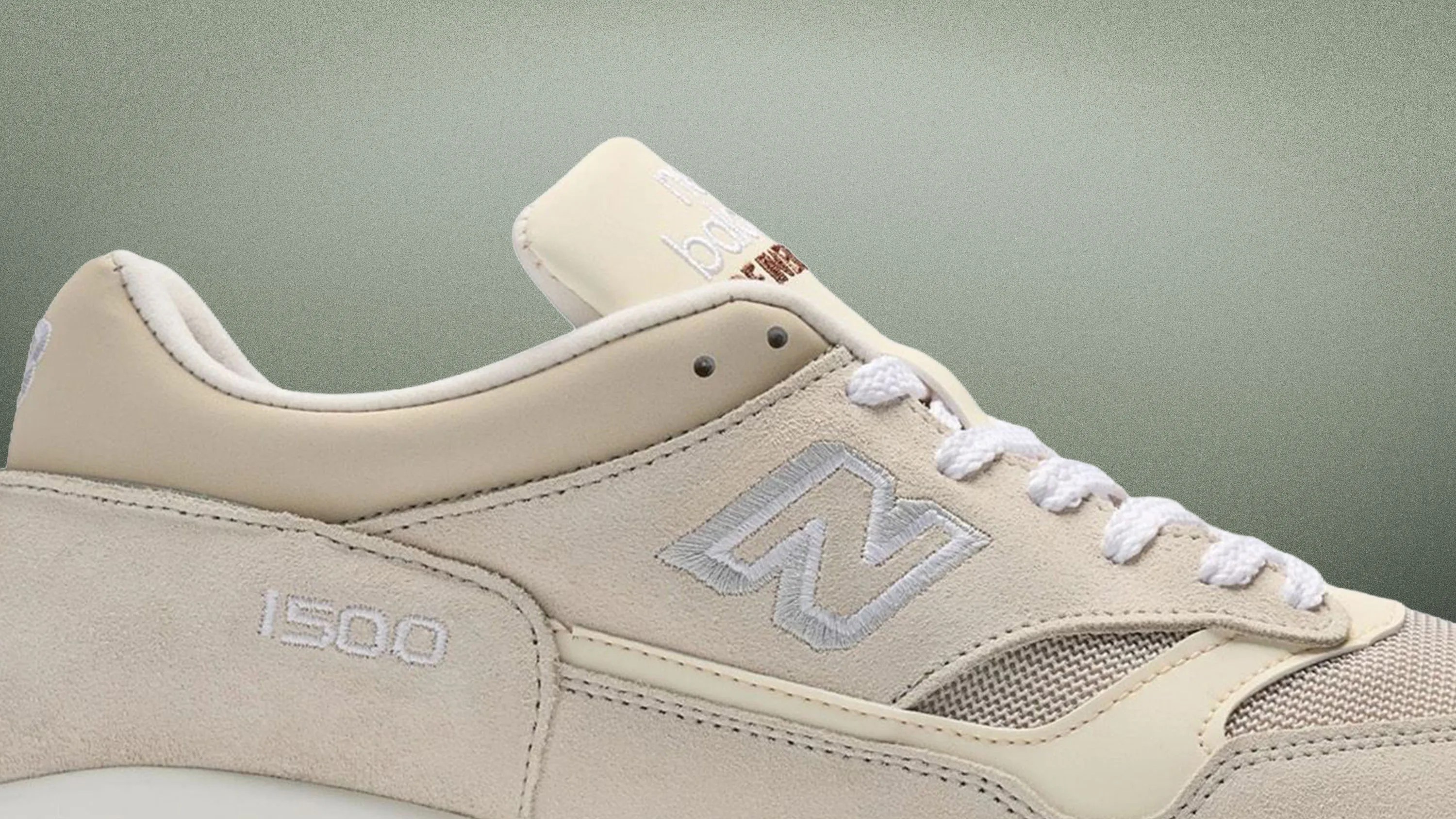 Beige New Balance 1500 sneaker with suede and mesh panels and white laces.