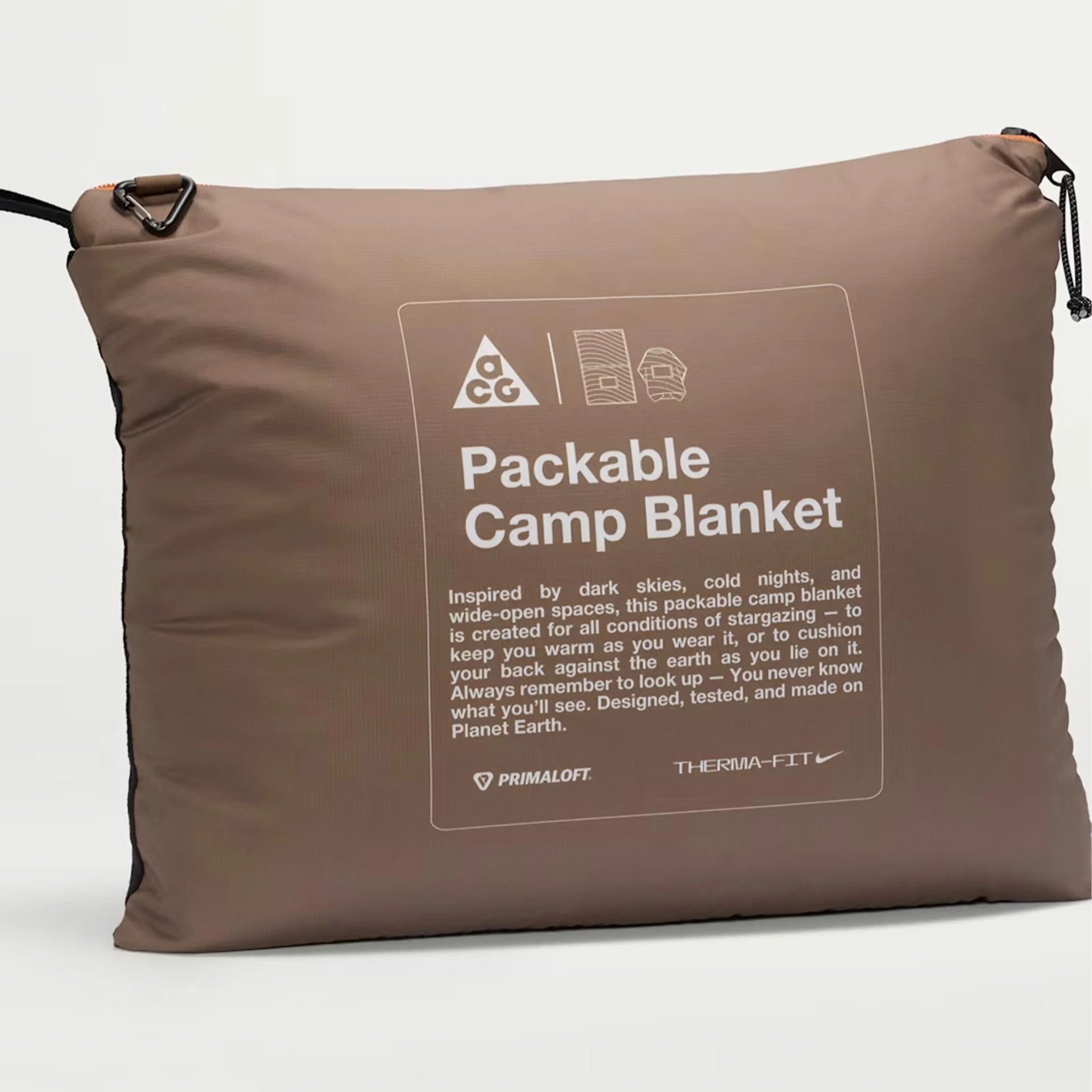 Brown packable camp blanket pouch with printed product description and logos.