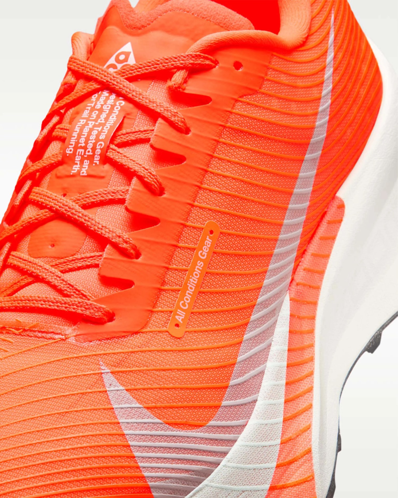 Bright orange running shoe with white sole and large white swoosh logo on the side.