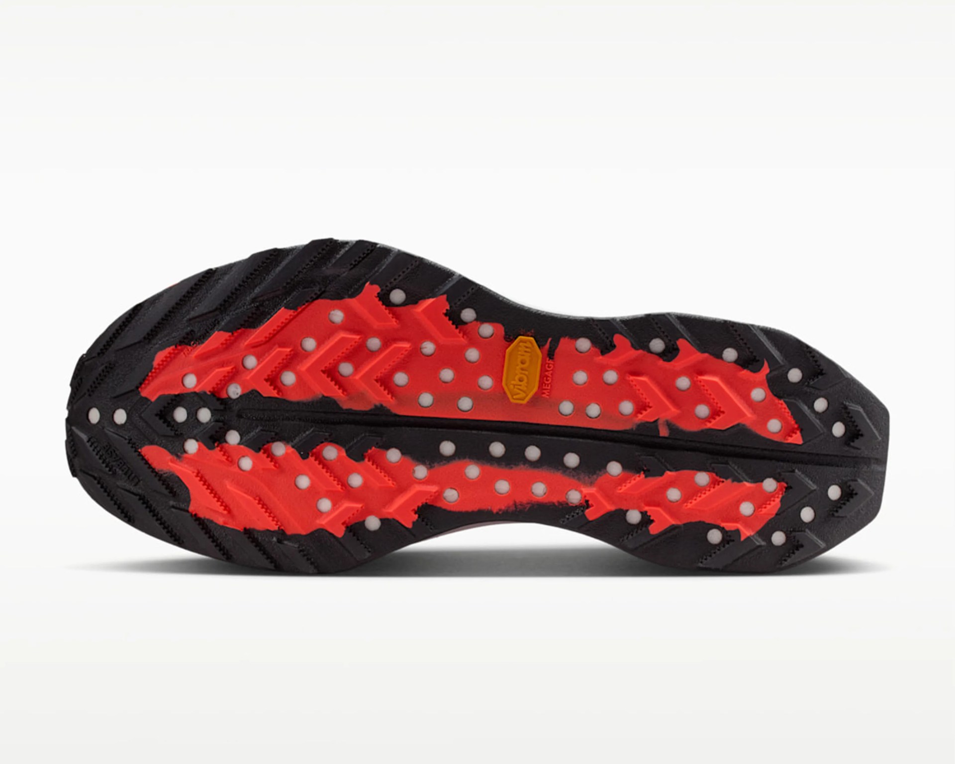 Black and red Vibram Megagrip shoe sole with circular white traction dots on a white background.