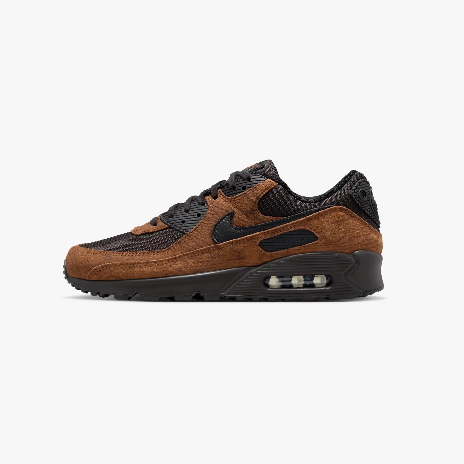 Brown suede and black mesh Nike Air Max sneaker with visible air cushion in sole.