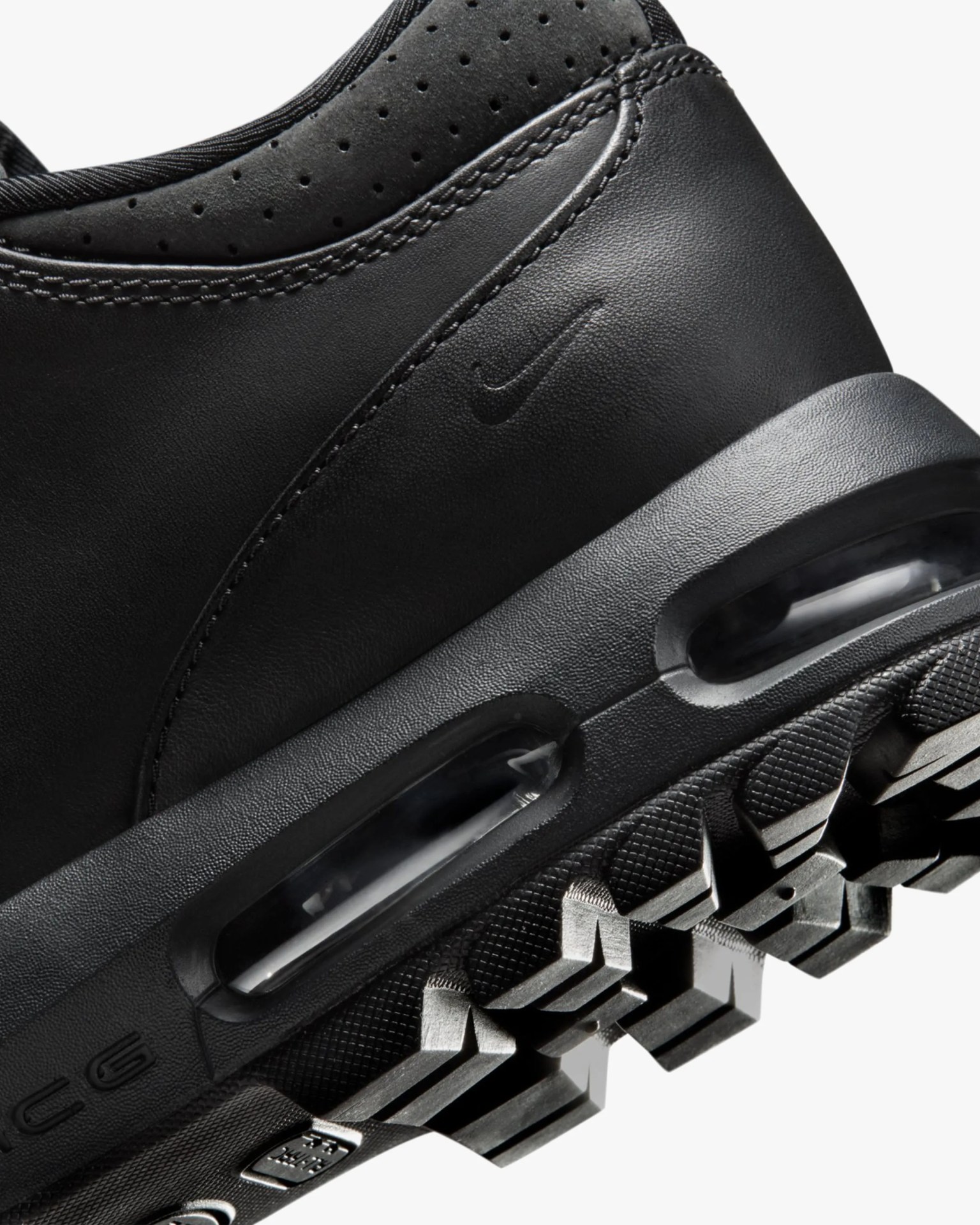 Close-up of black Nike Air Max shoe heel with visible air cushioning and textured sole.