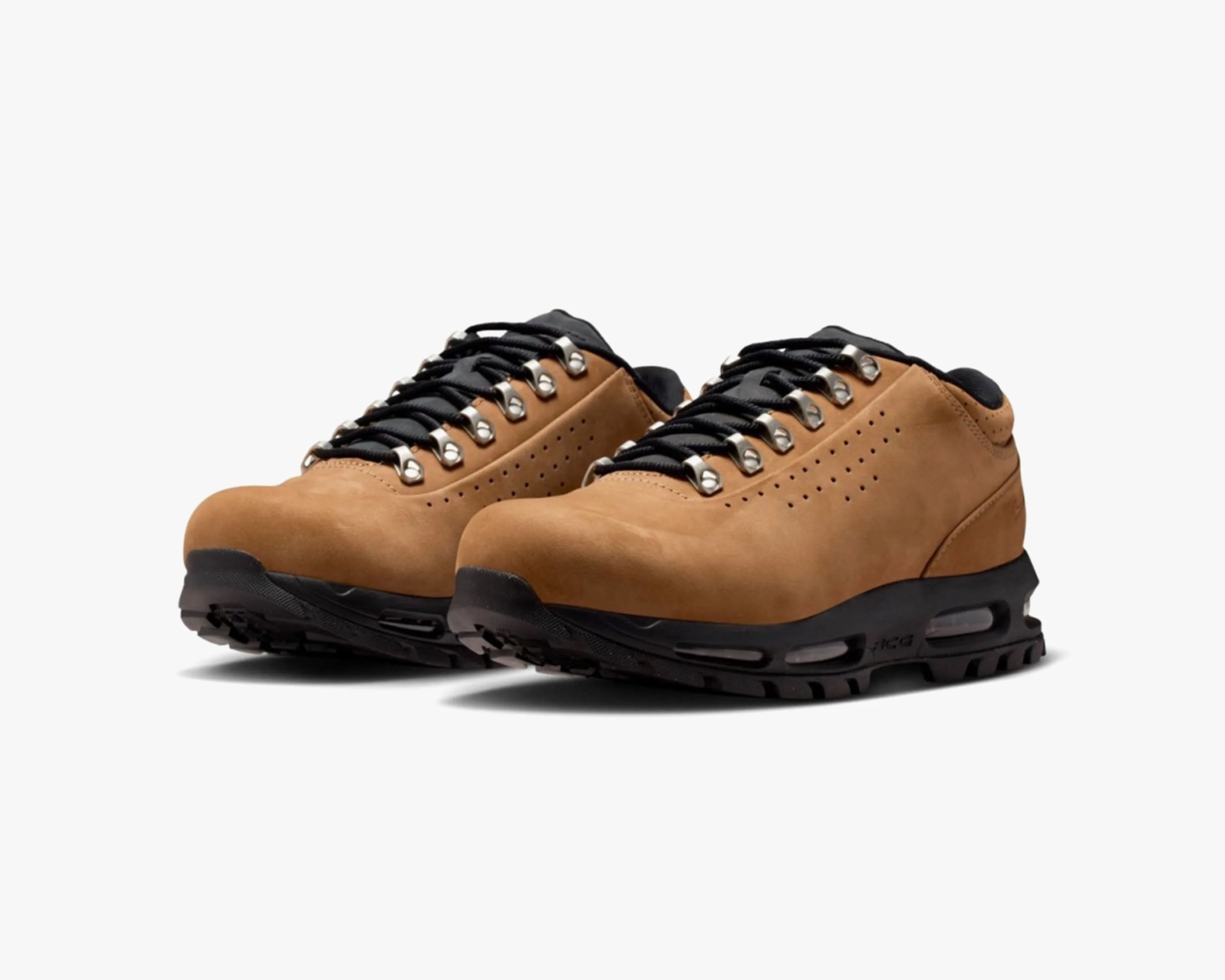 Pair of tan leather hiking shoes with black soles and black laces on a white background.