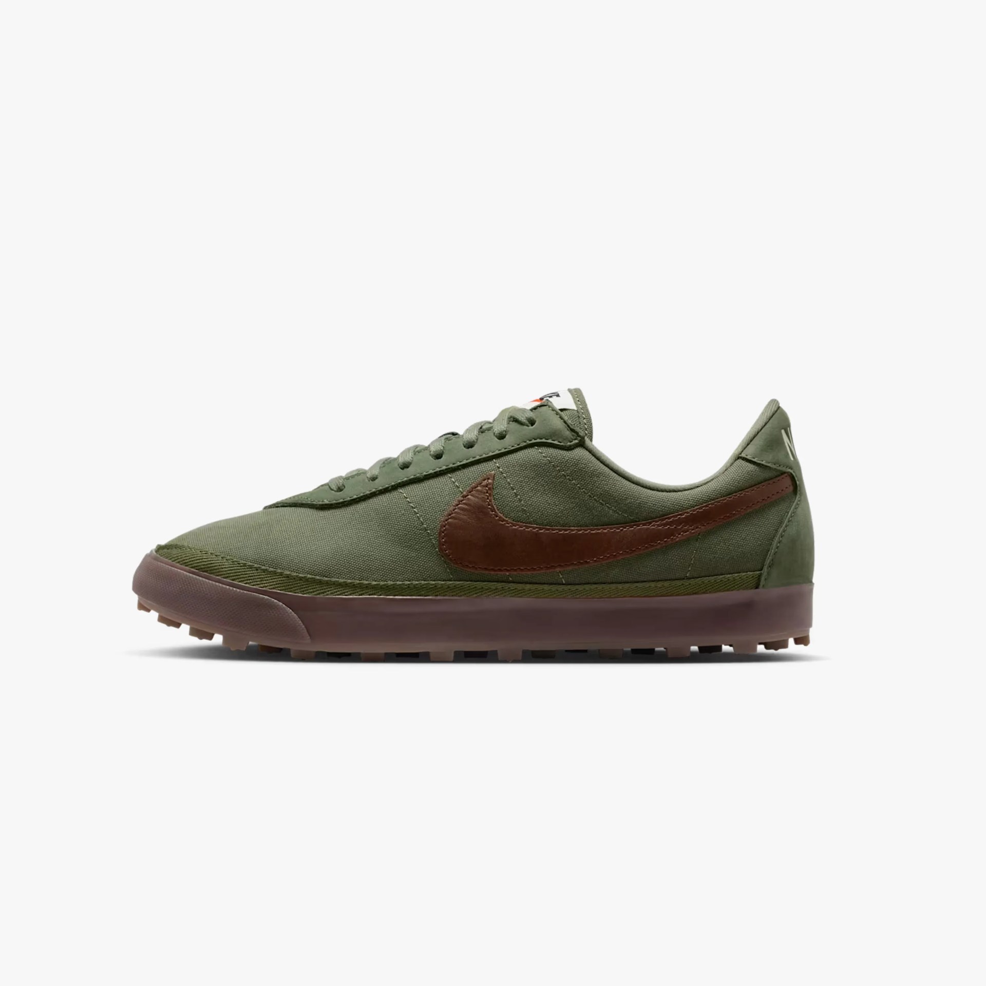 Olive green low-top sneaker with brown leather Nike swoosh and gum sole.
