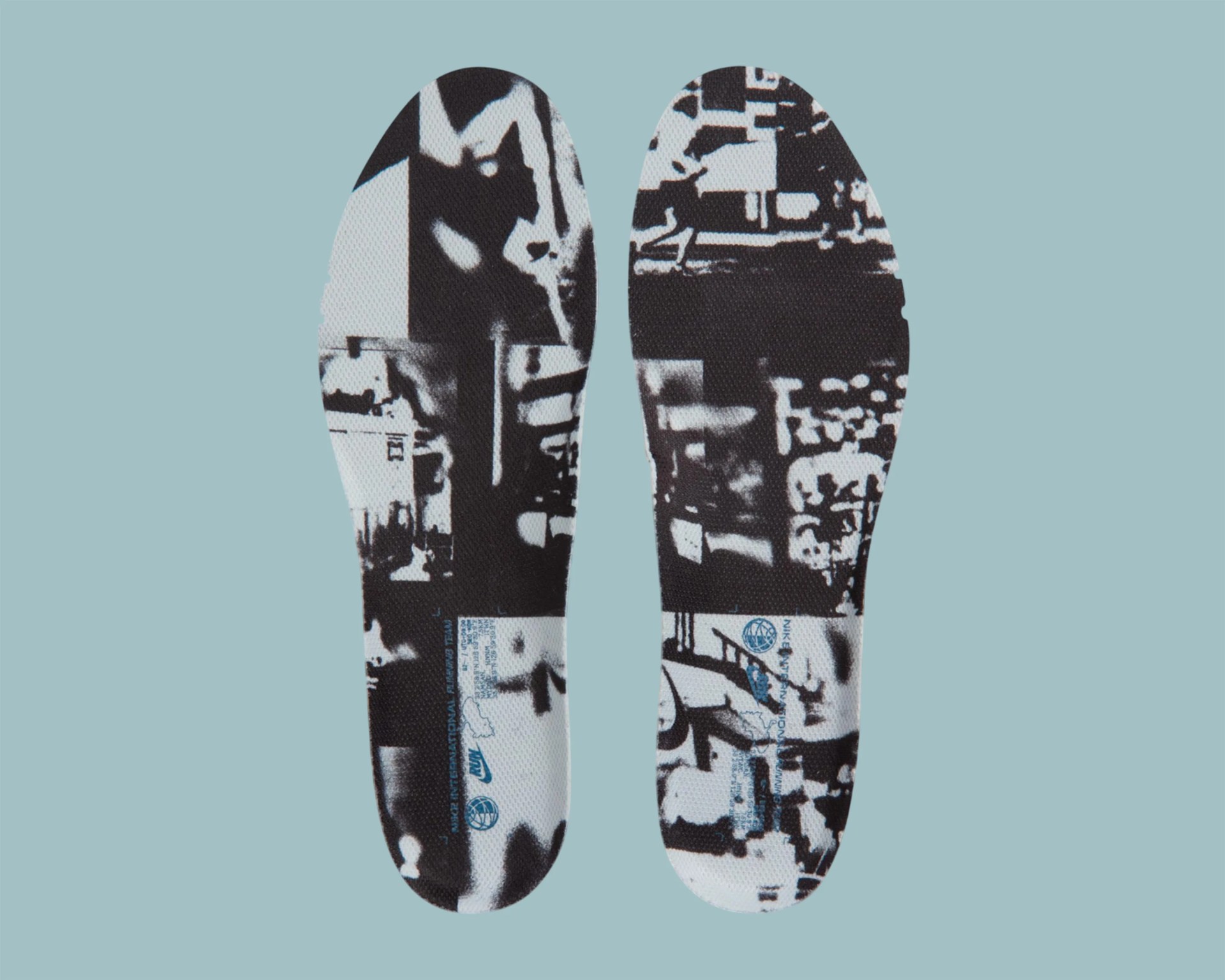 Pair of black and white patterned shoe insoles with blue text and logos on a light blue background.