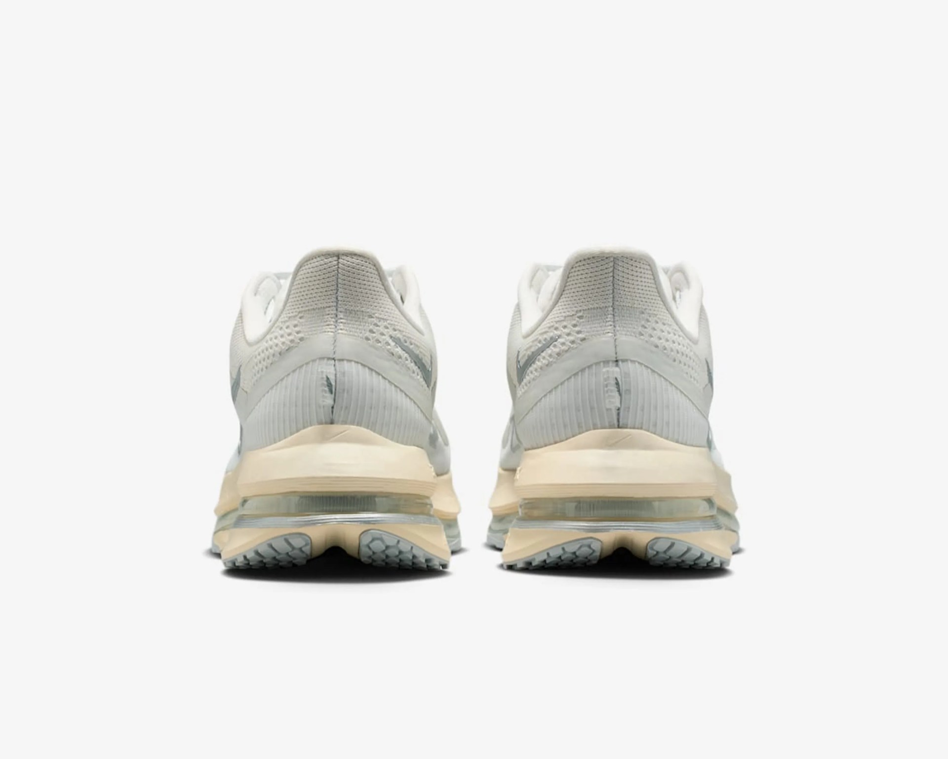 Pair of light gray and beige running shoes shown from the back with visible air cushioning in the sole.
