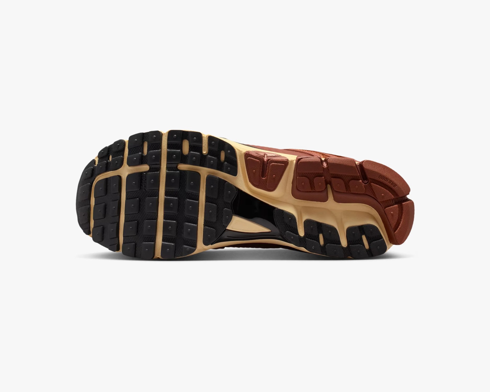 Sole of a sneaker with black, beige, and brown rubber tread and segmented grip patterns.