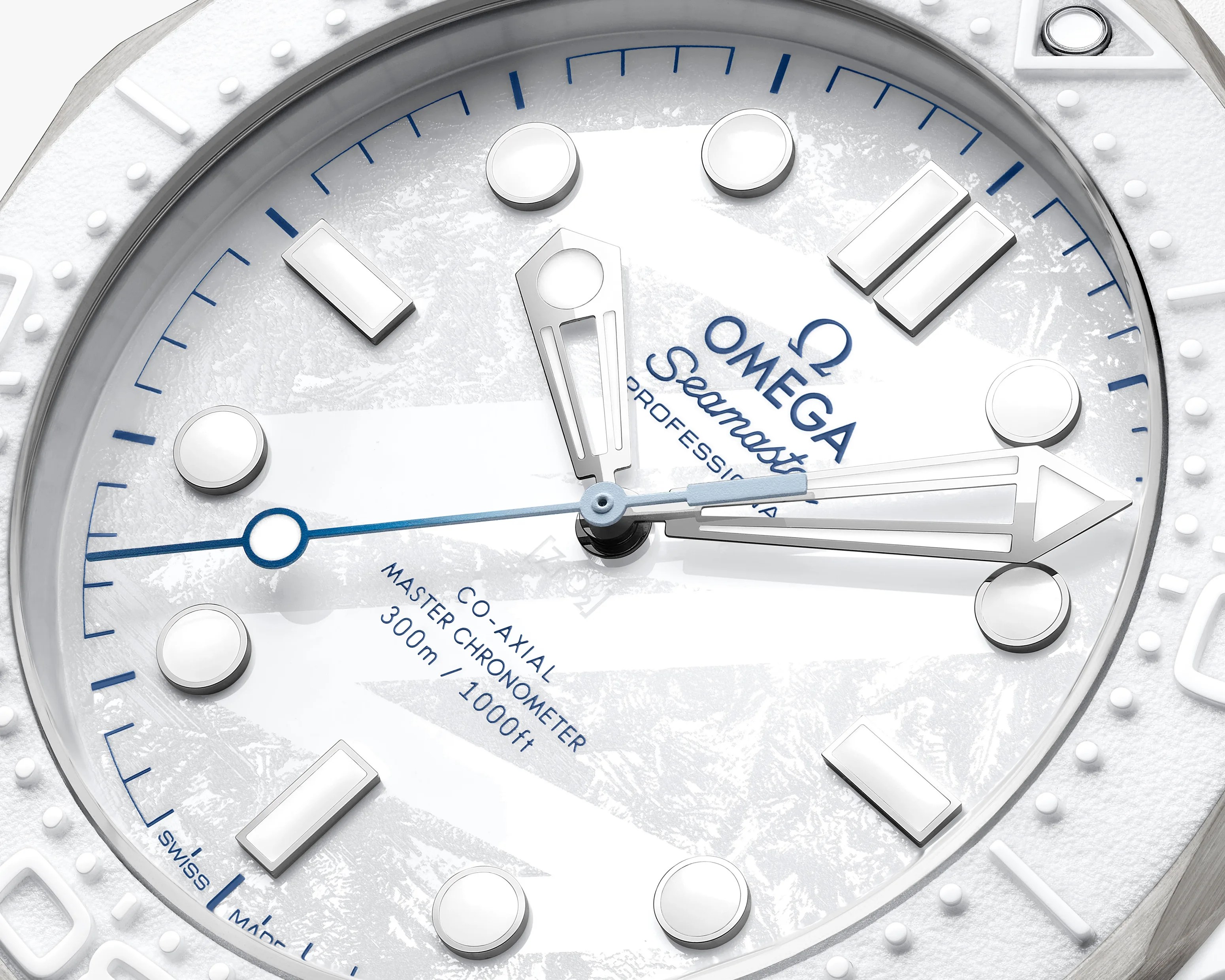 Close-up of a white Omega Seamaster watch face with blue accents and silver hour markers.