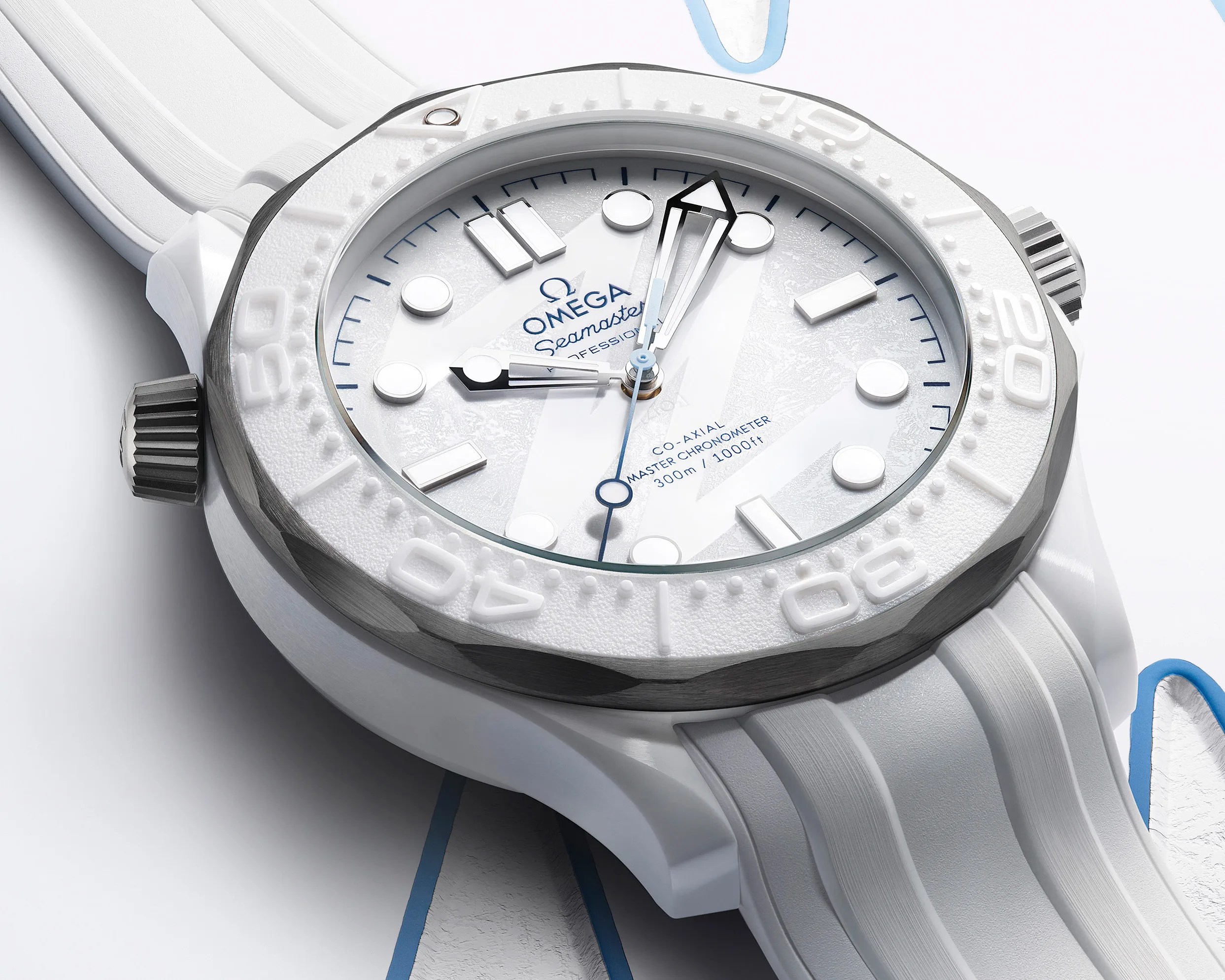 White Omega Seamaster wristwatch with textured dial, white bezel, and white rubber strap.