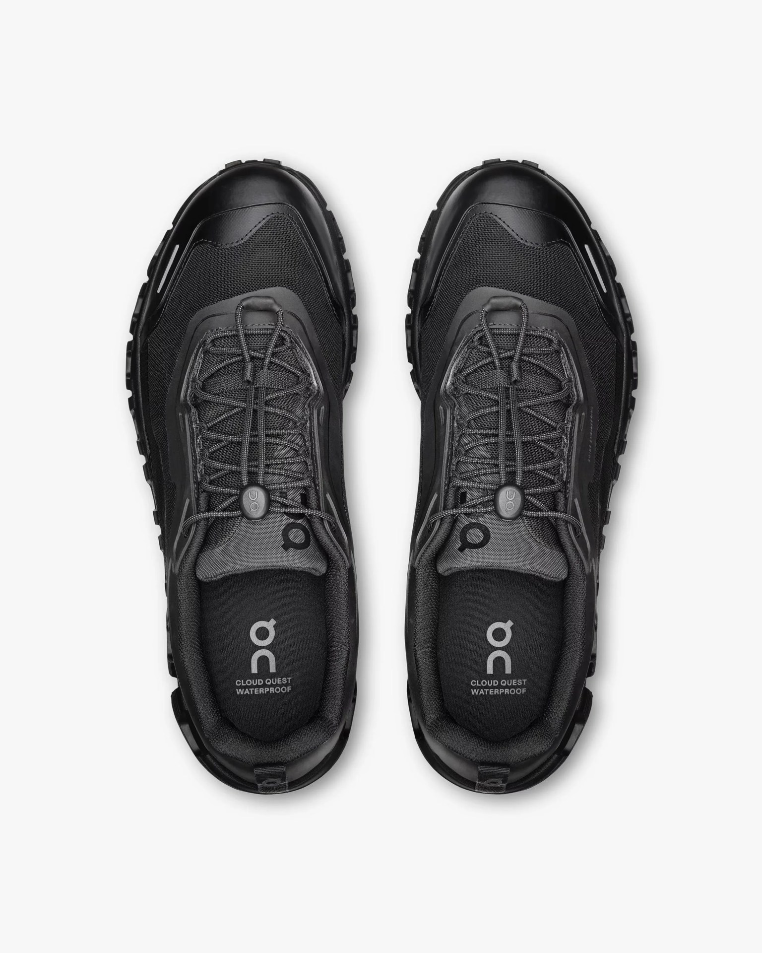 Pair of black On Cloud Quest Waterproof sneakers with elastic laces viewed from above on a white background.