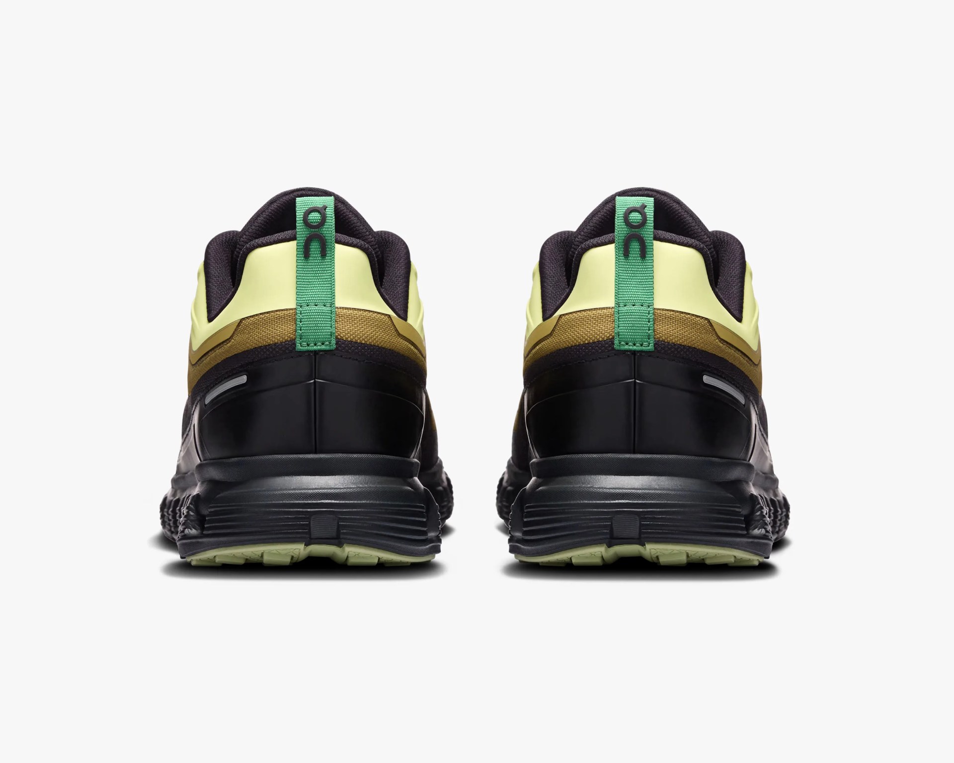 Pair of black, yellow, and brown running shoes shown from the back with green pull tabs.
