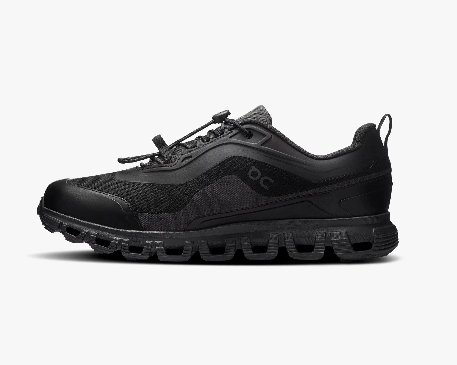 Black low-top athletic shoe with mesh upper, lace toggle, and segmented sole on a white background.