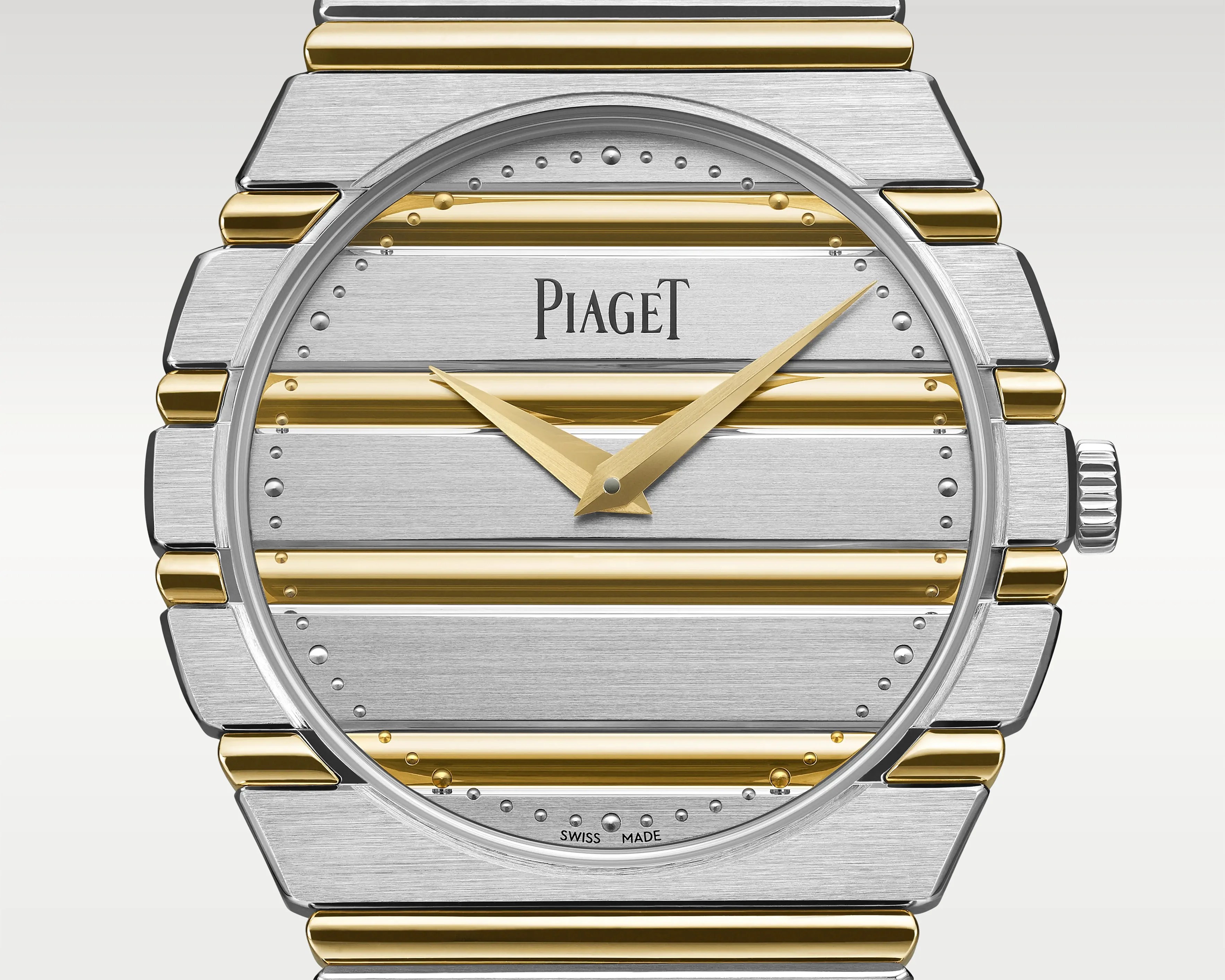 Silver and gold striped Piaget wristwatch face with gold hands and Swiss Made label.