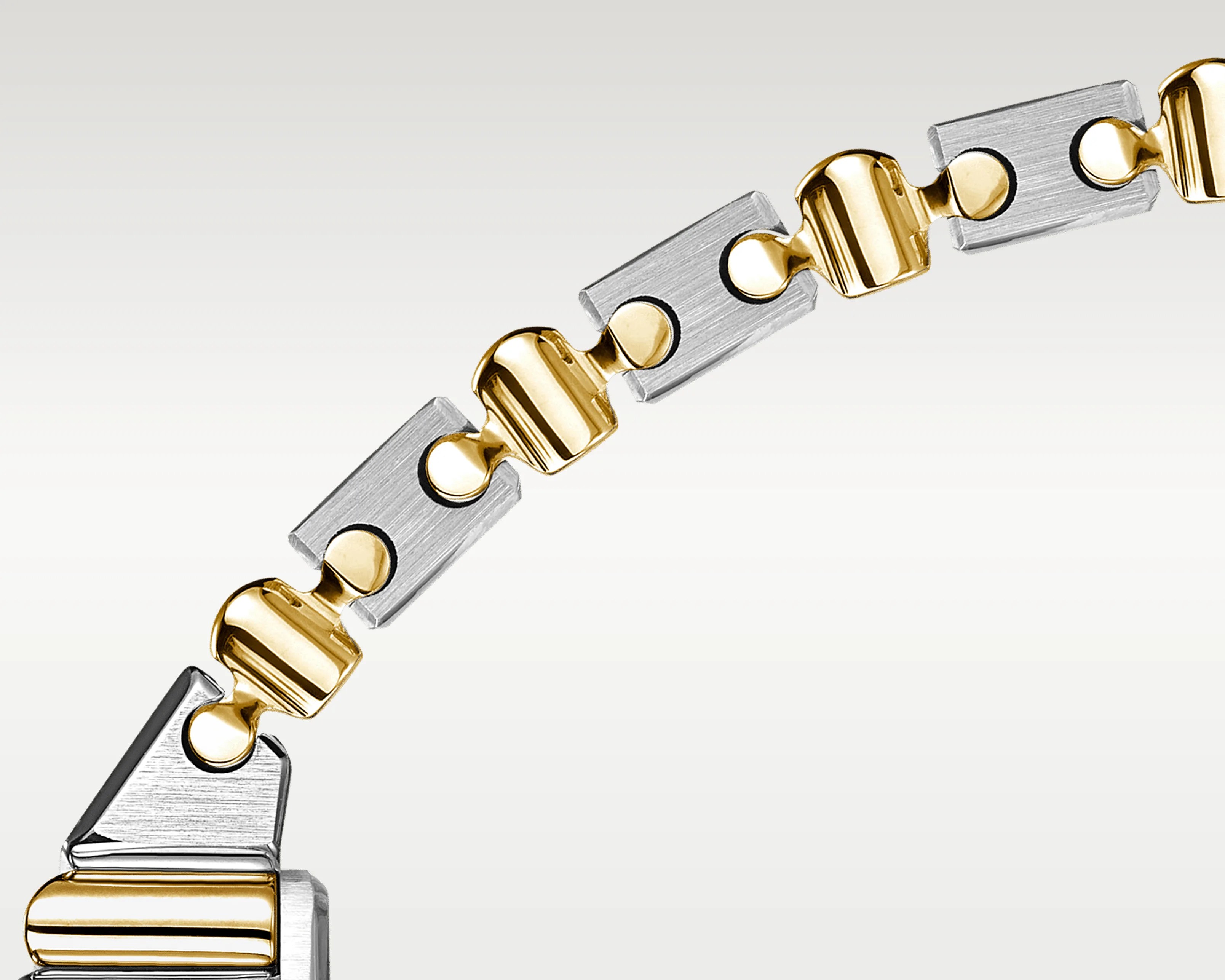 Two-tone metal bracelet with alternating brushed silver rectangular and polished gold curved links.