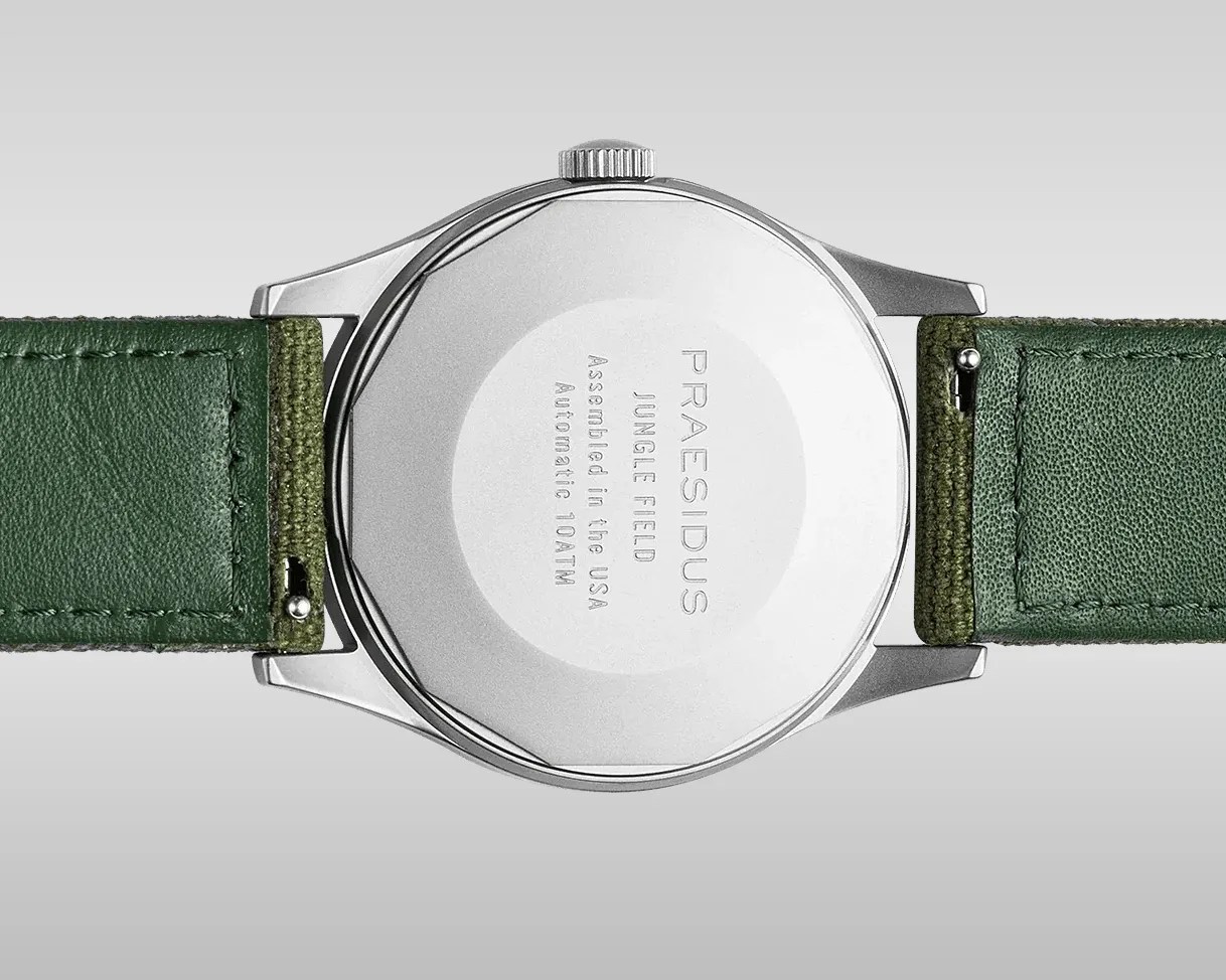 Back of a silver Praesidus Jungle Field watch with green leather and fabric strap.